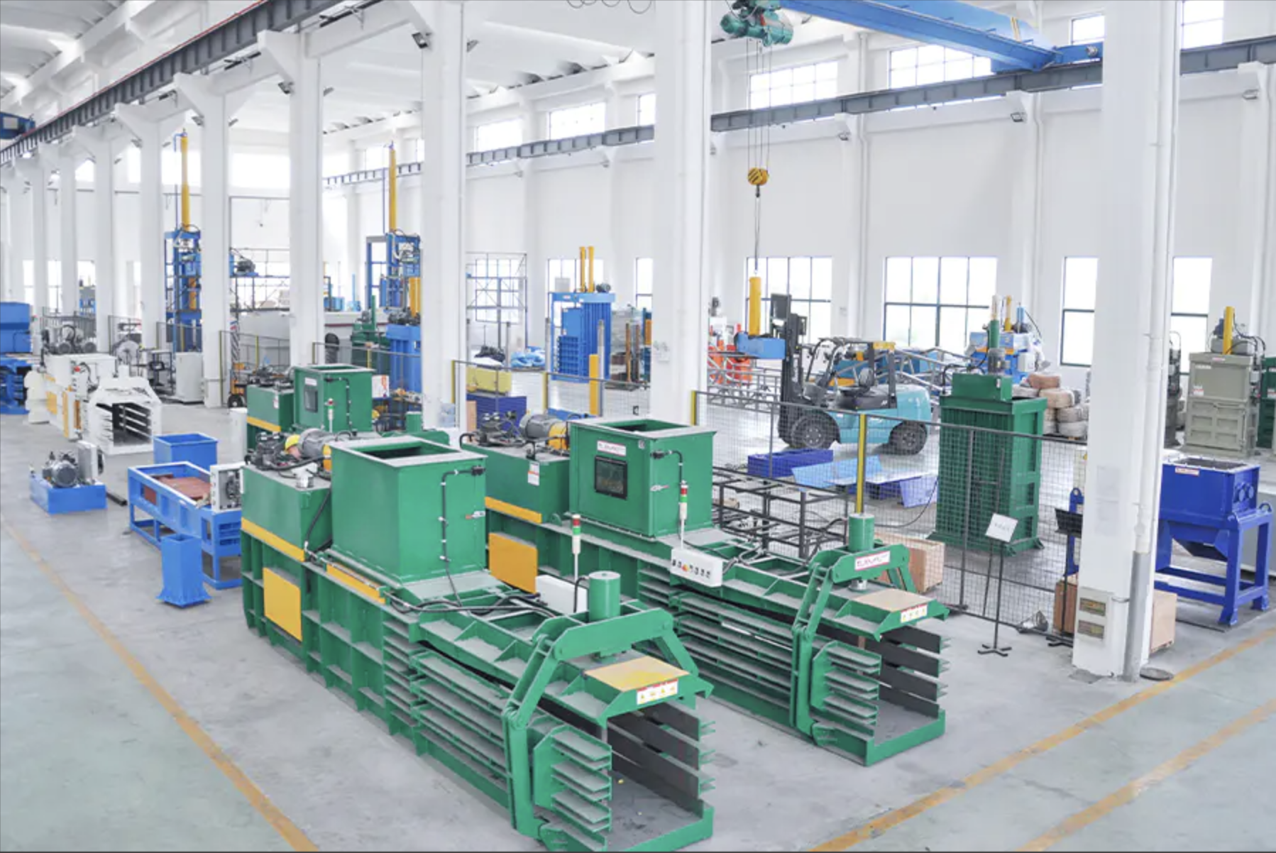 Hydraulic baler machine assembly workshop showing production line setup