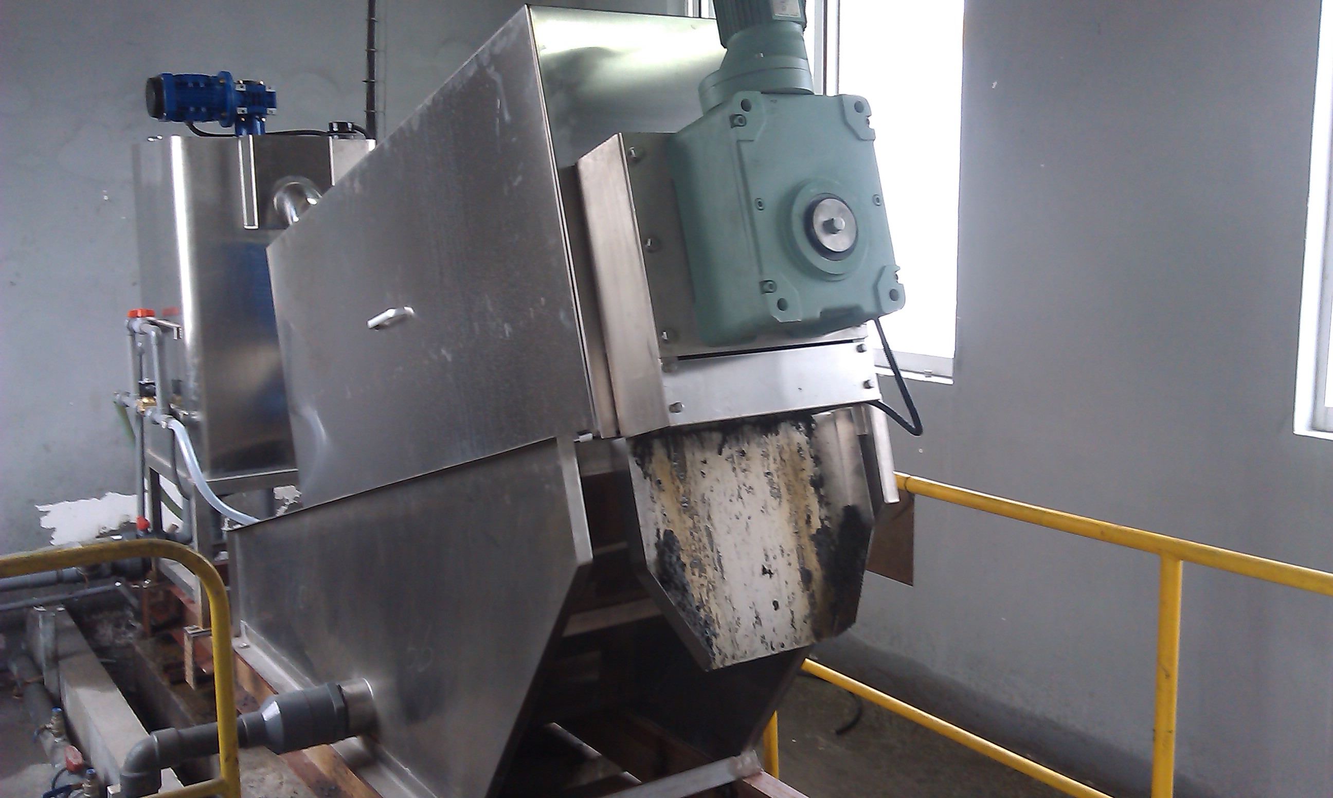 Screw press sludge dewatering machine operating at a vegetable oil processing plant in China