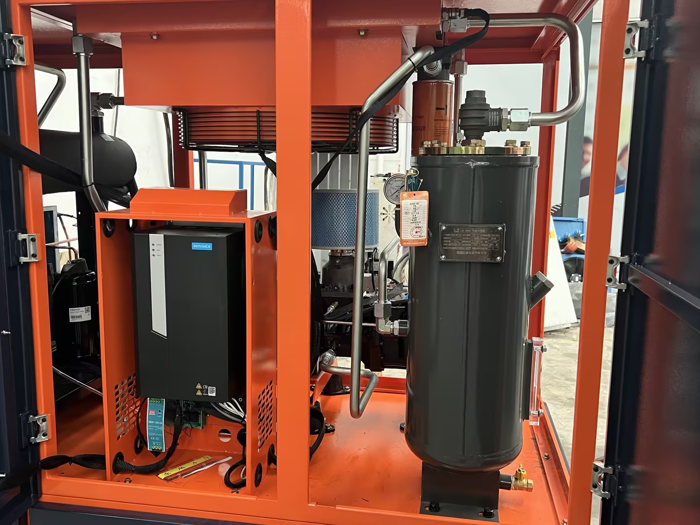 Industrial screw air compressor in a factory setting