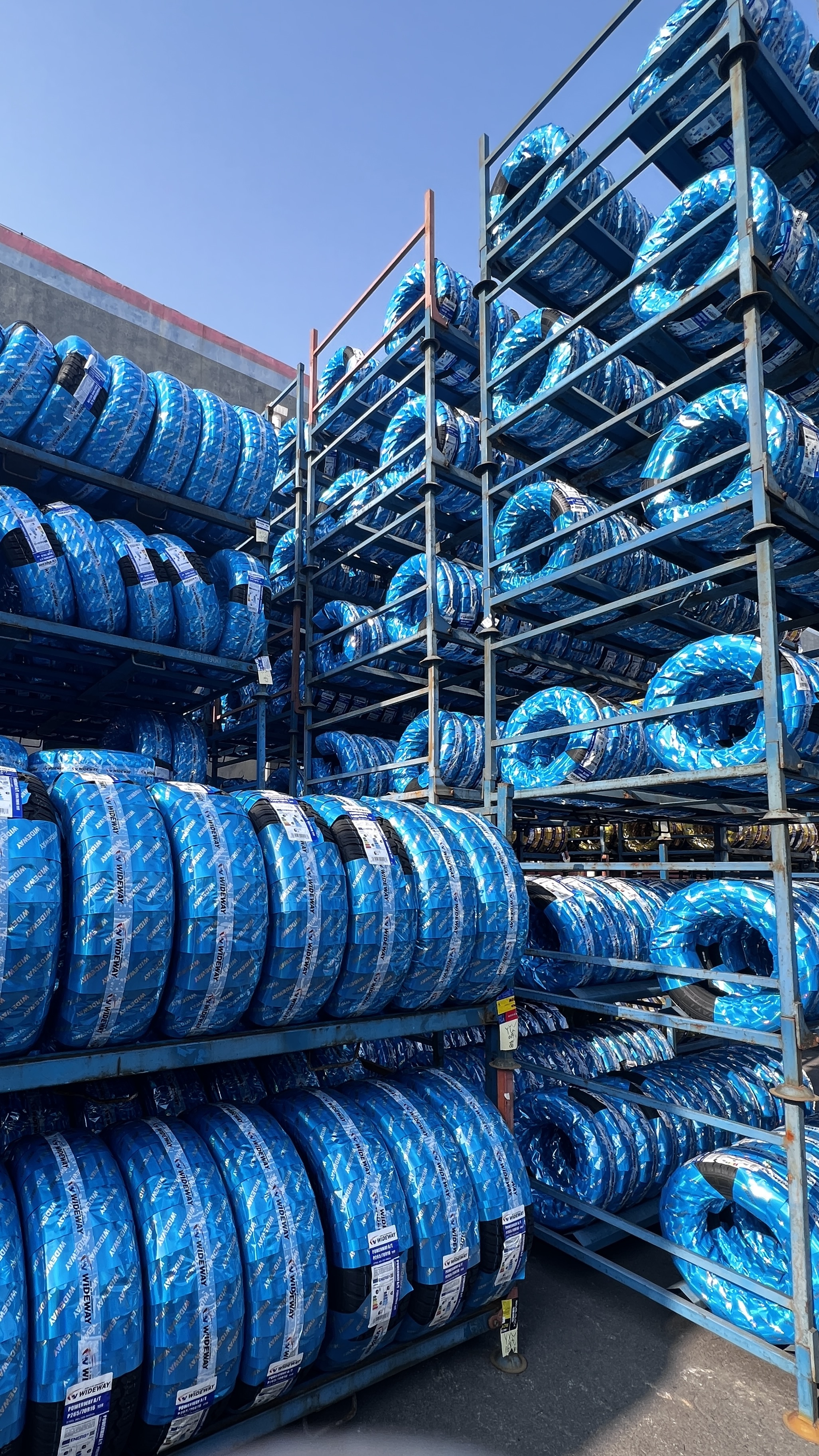 Tire with protective wrapping at manufacturing site