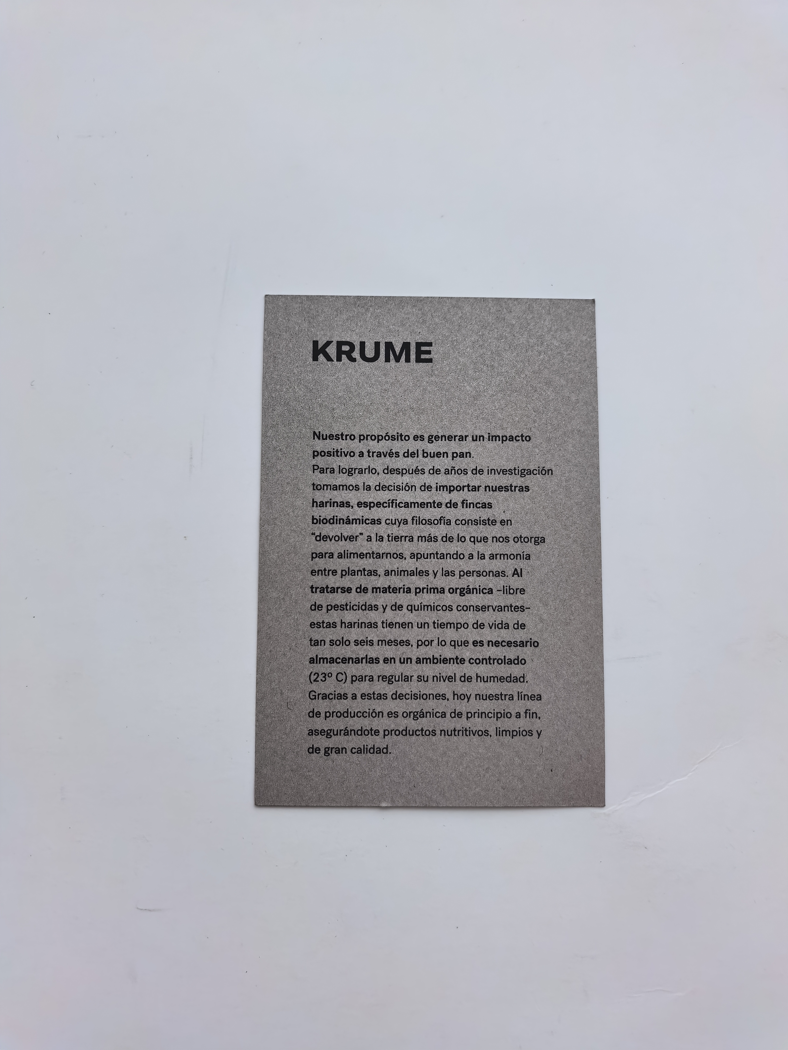 Custom paper bags and hang tags produced for a fashion brand, demonstrating consistent print quality across batches