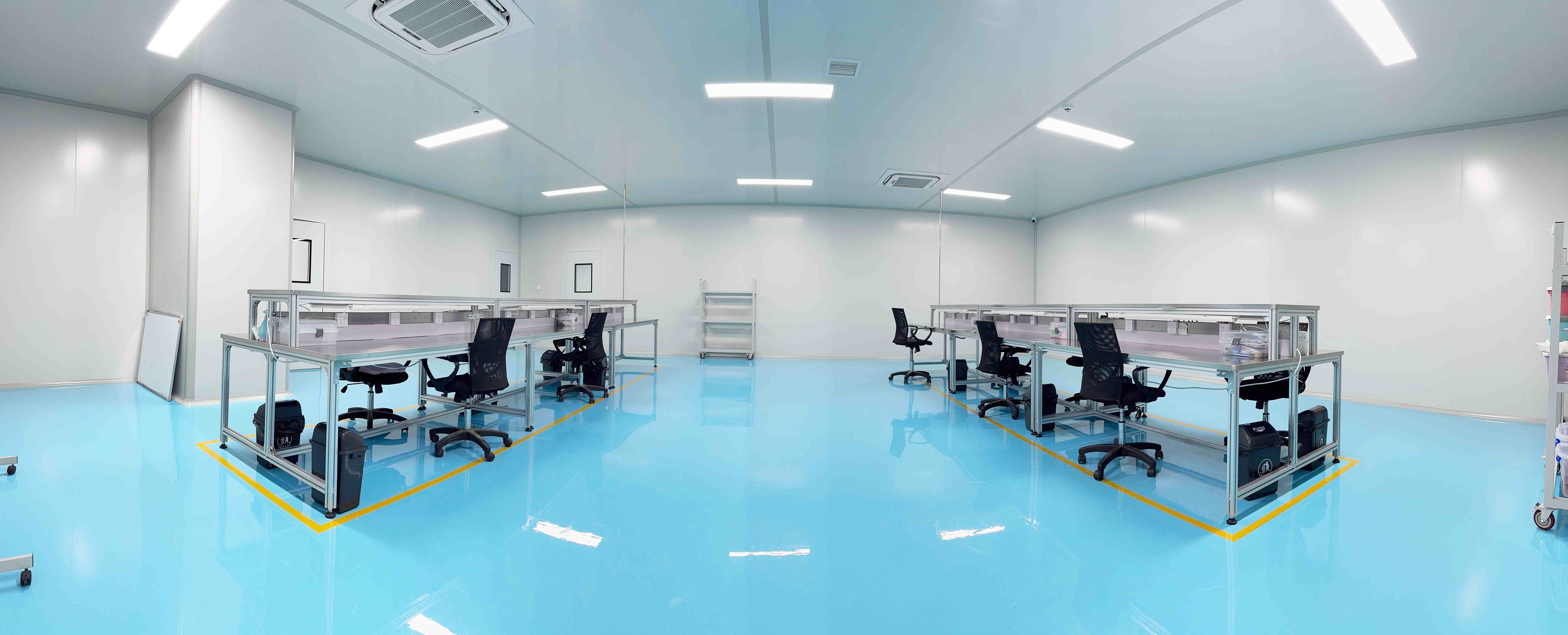 Professional tattoo cartridge needle manufacturing workshop showing automated assembly line