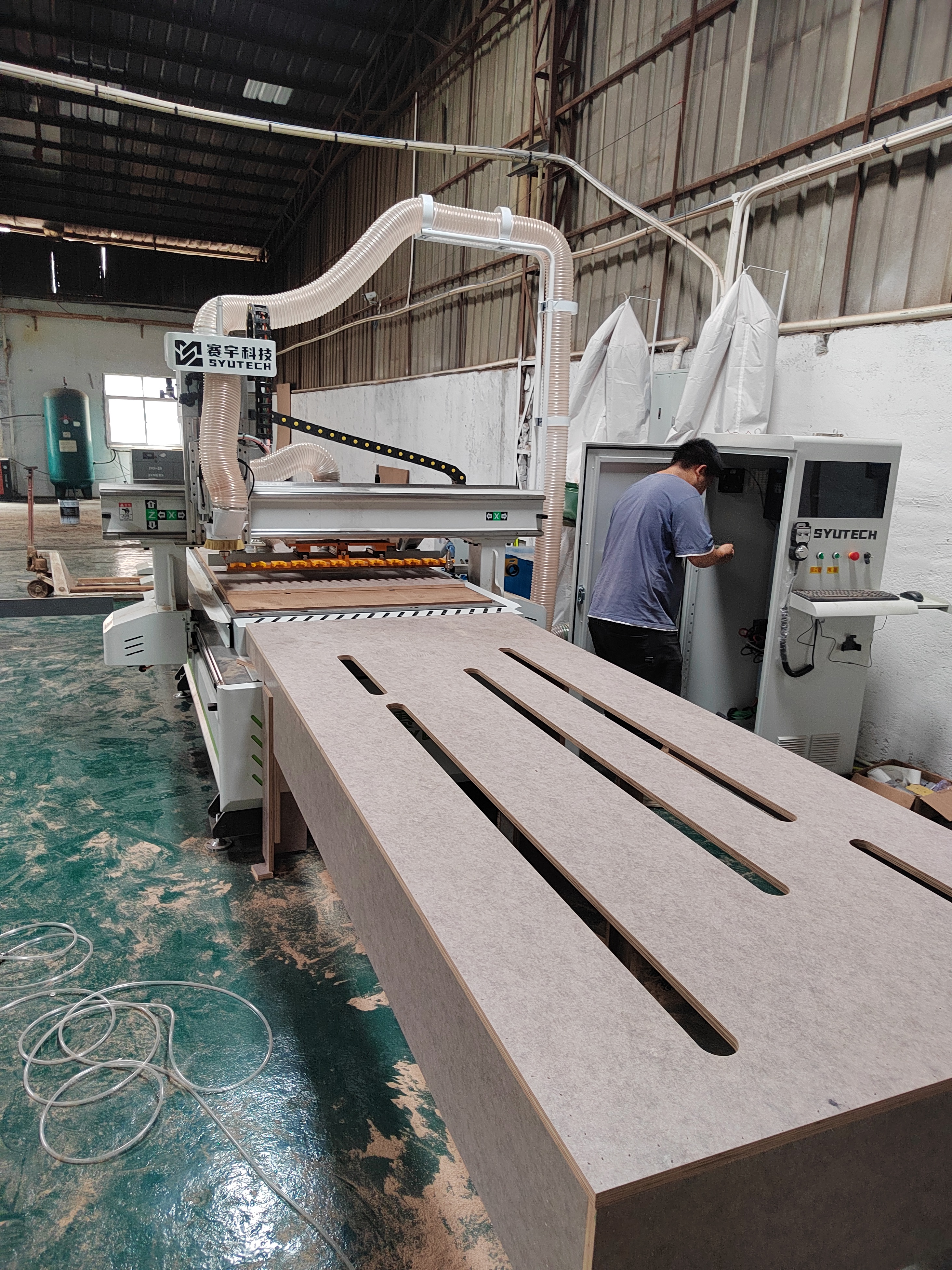 CNC router machine running in a panel furniture workshop