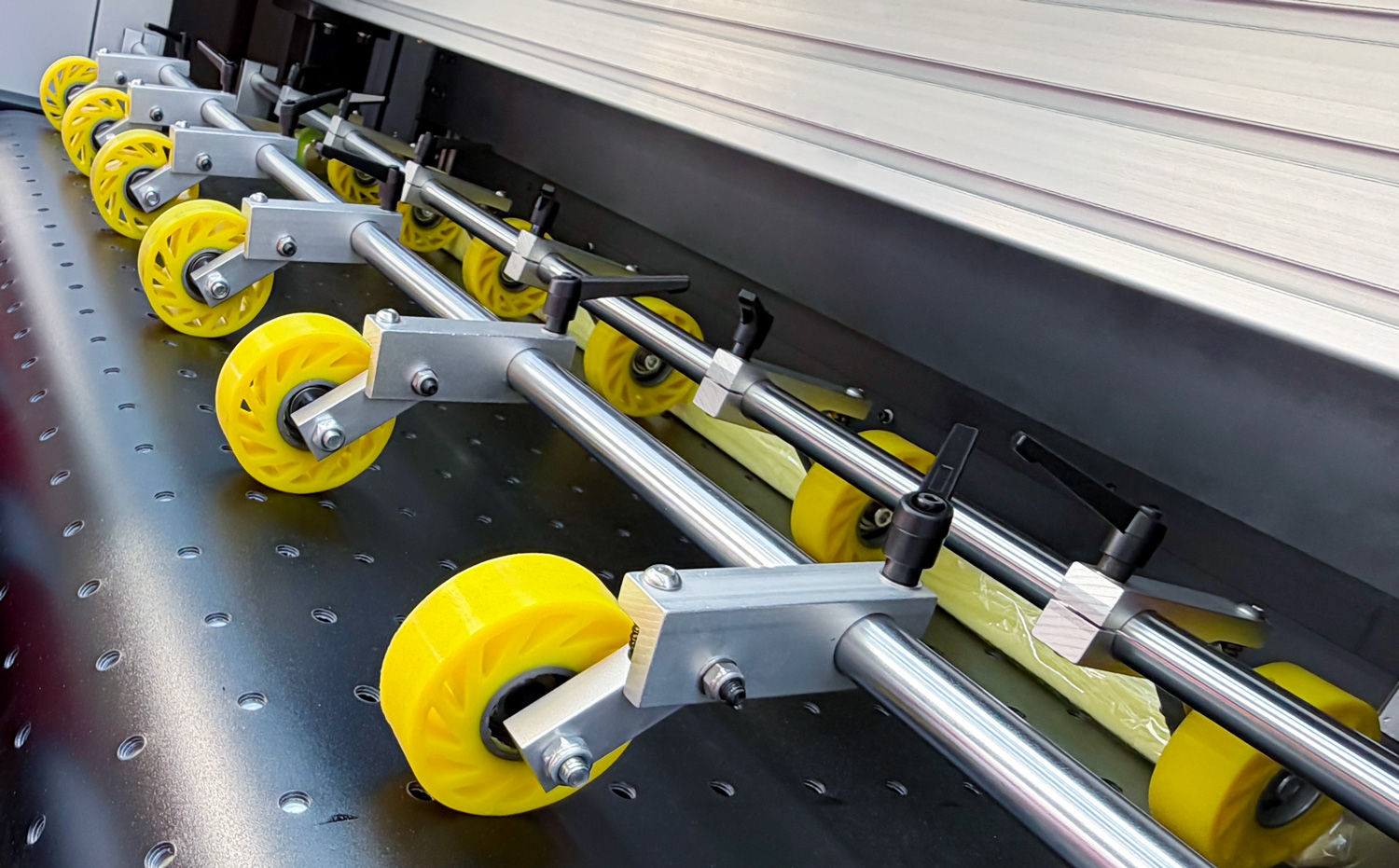 Multiple paper feed rollers ensure smooth material output after printing.