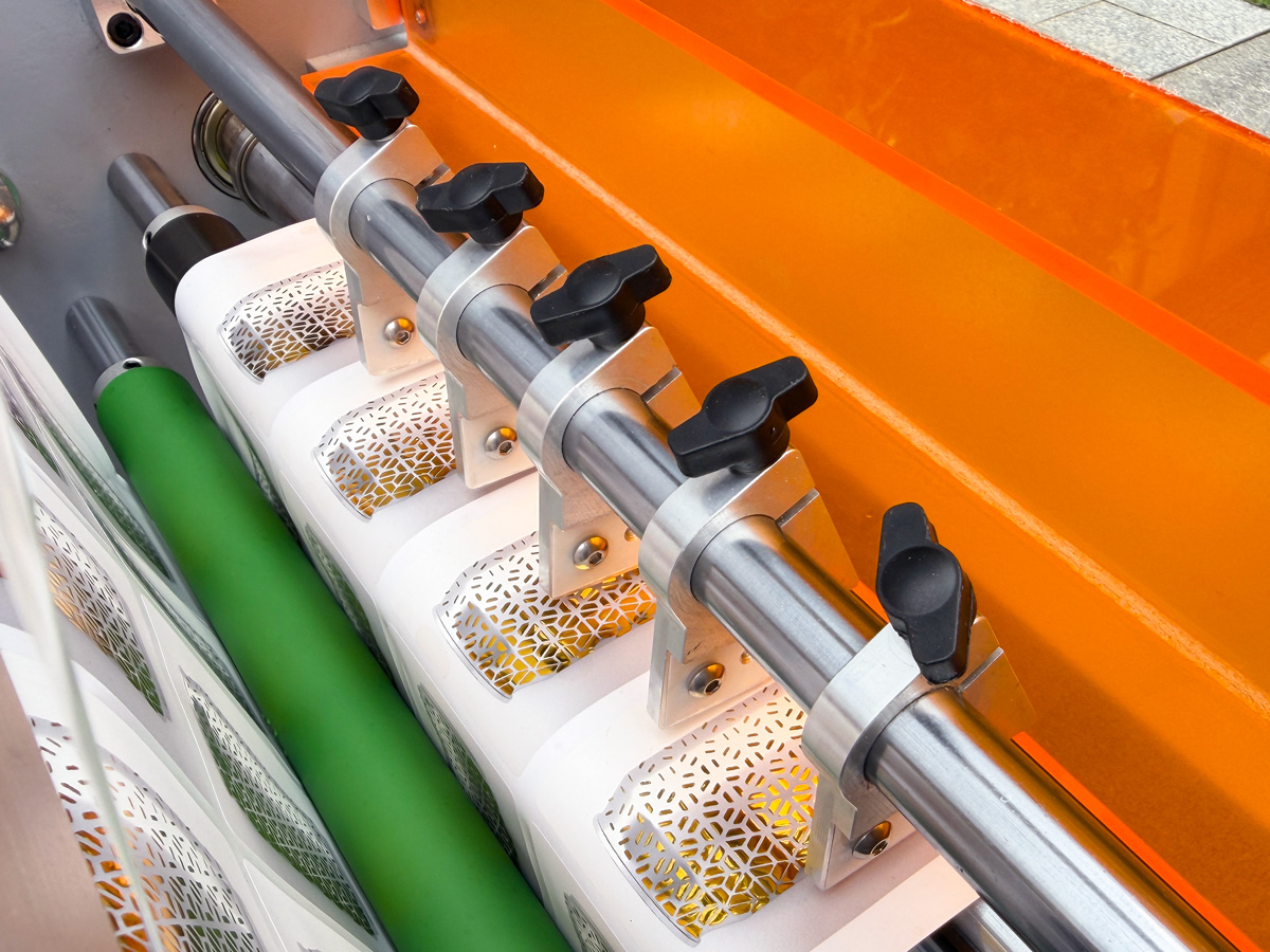 Multiple slitting knives to achieve slitting of materials of different widths