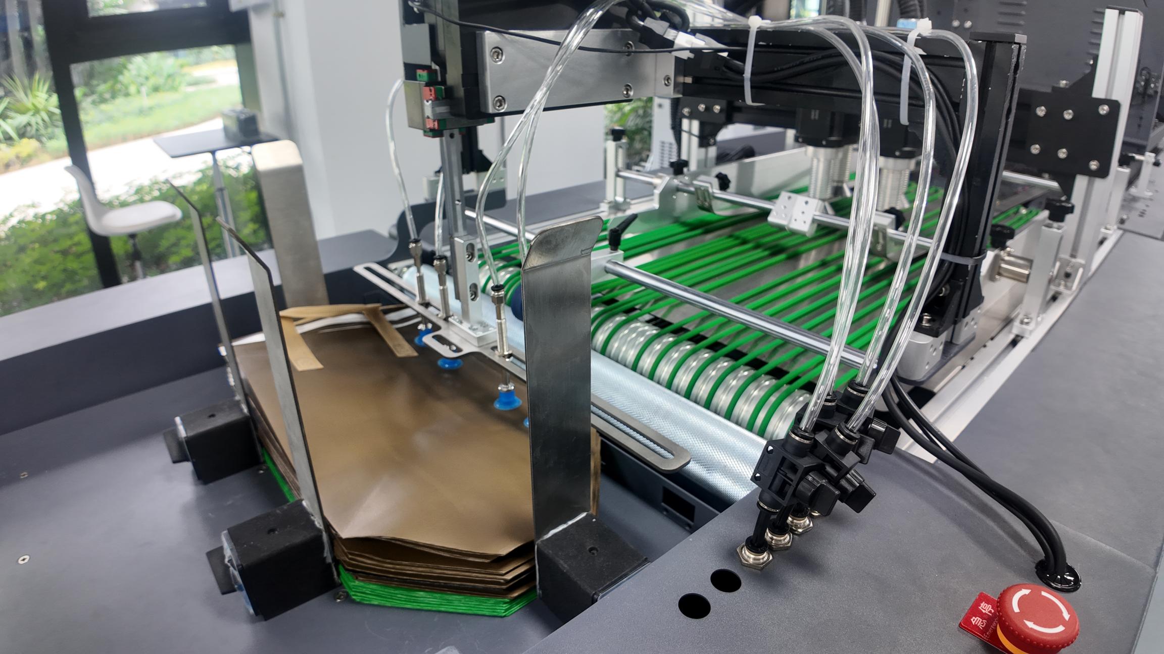 Automatic feeding system delivering non-woven bags to a single pass printer