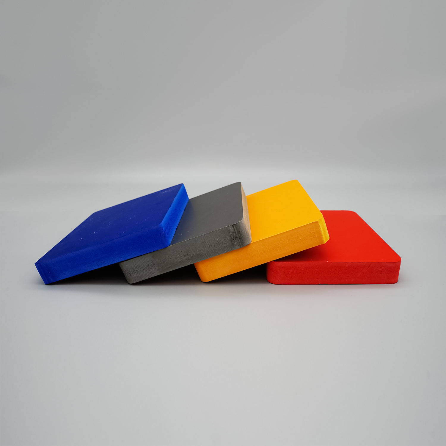 Colored PVC foam boards displayed on shelves, showcasing various color options for signage and interior applications
