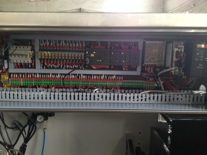 Separate electrical cabinet mounted on the upper side of a cartoning machine body for maintenance access and electrical safety servicing