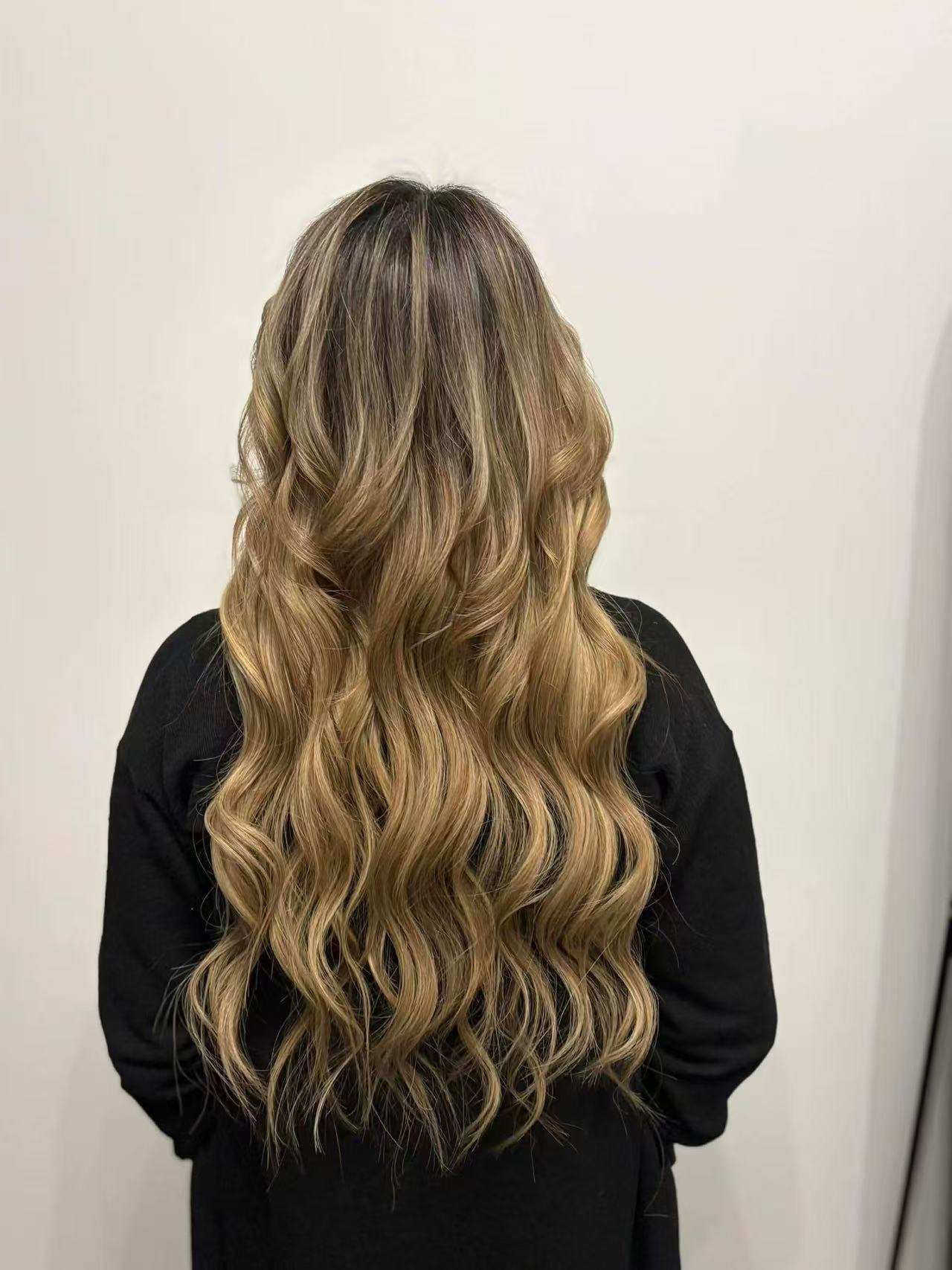 Hair extension application in a professional salon setting