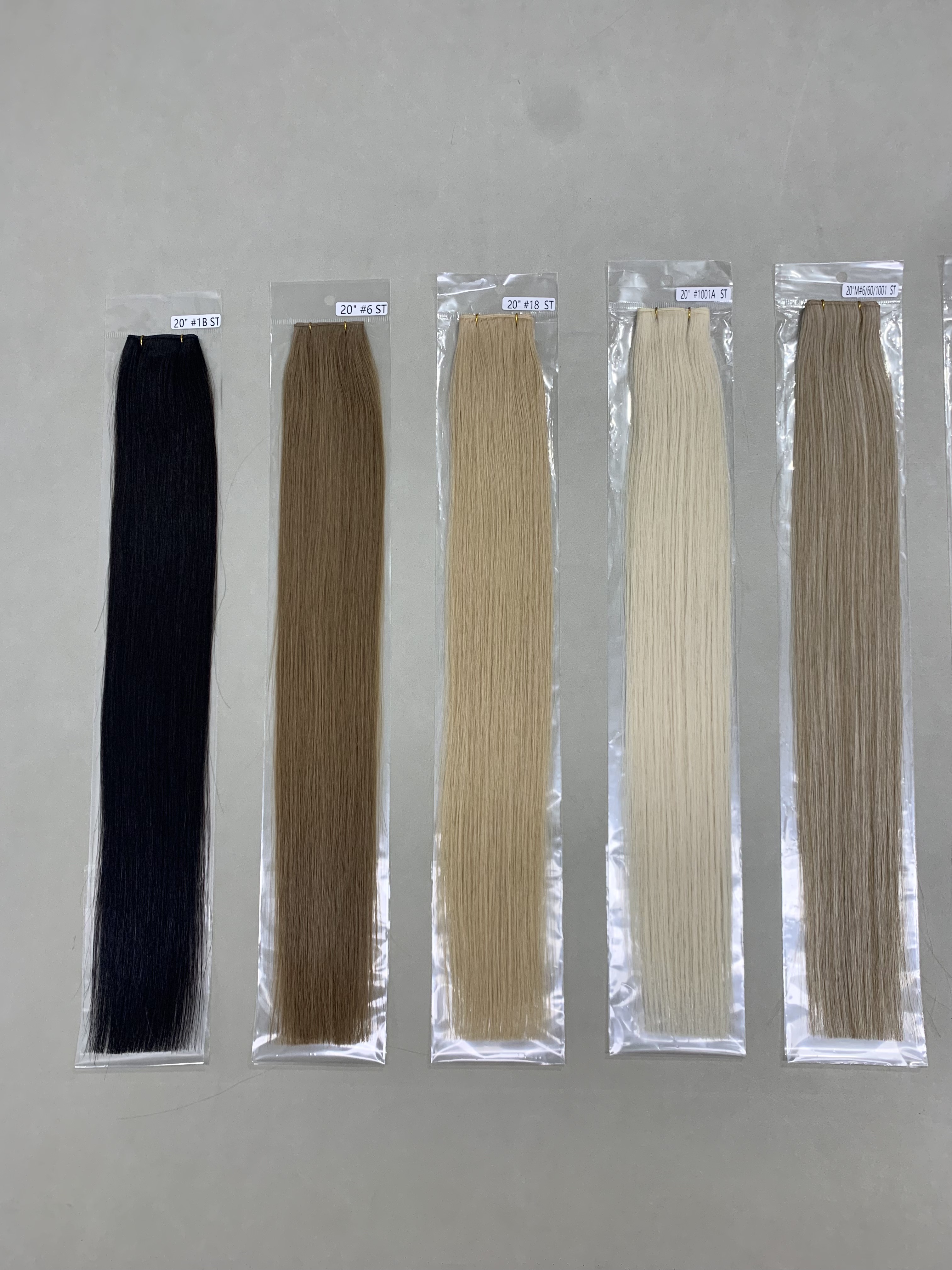 Close-up of a 20-inch solid color genius weft hair extension showing thin machine-weft construction