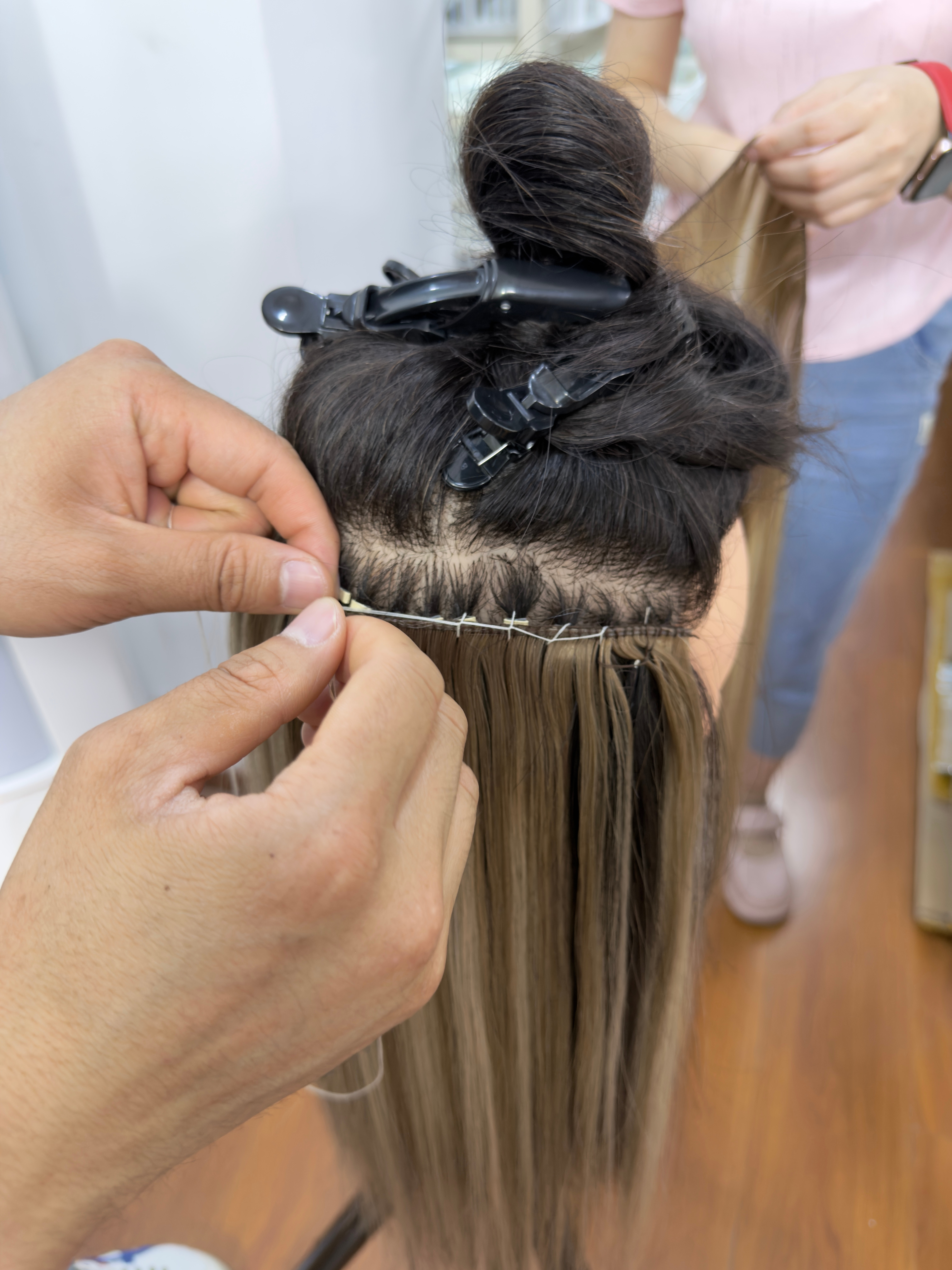 Genius weft hair extensions application case in a salon setting
