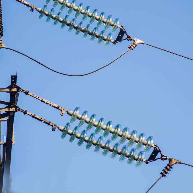 Glass insulators are used in overhead power lines<p class=