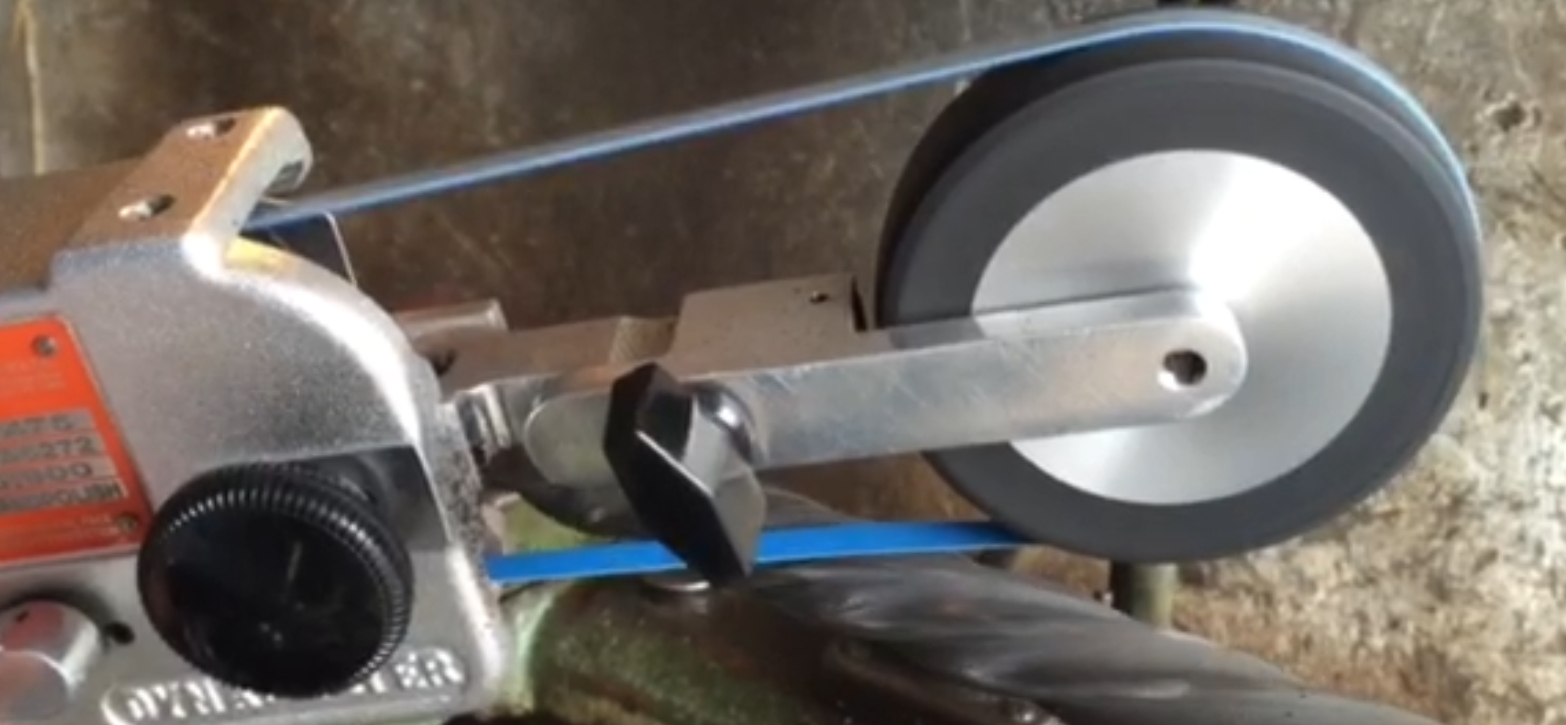 Diamond belt grinding application on a curved metal part