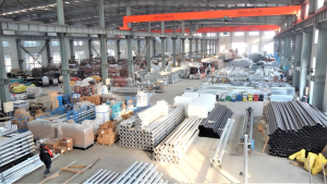 Workshop storage and assembly area, stacked with finished irrigation metal components.