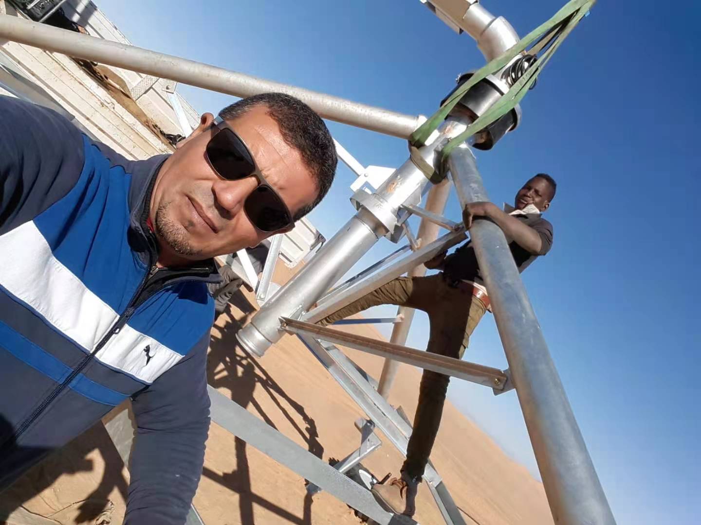 Client inspection and truss installation check during center pivot irrigation system assembly in Algeria