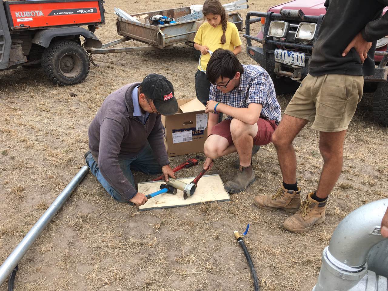 Client and engineers assembling pivot irrigation accessories together