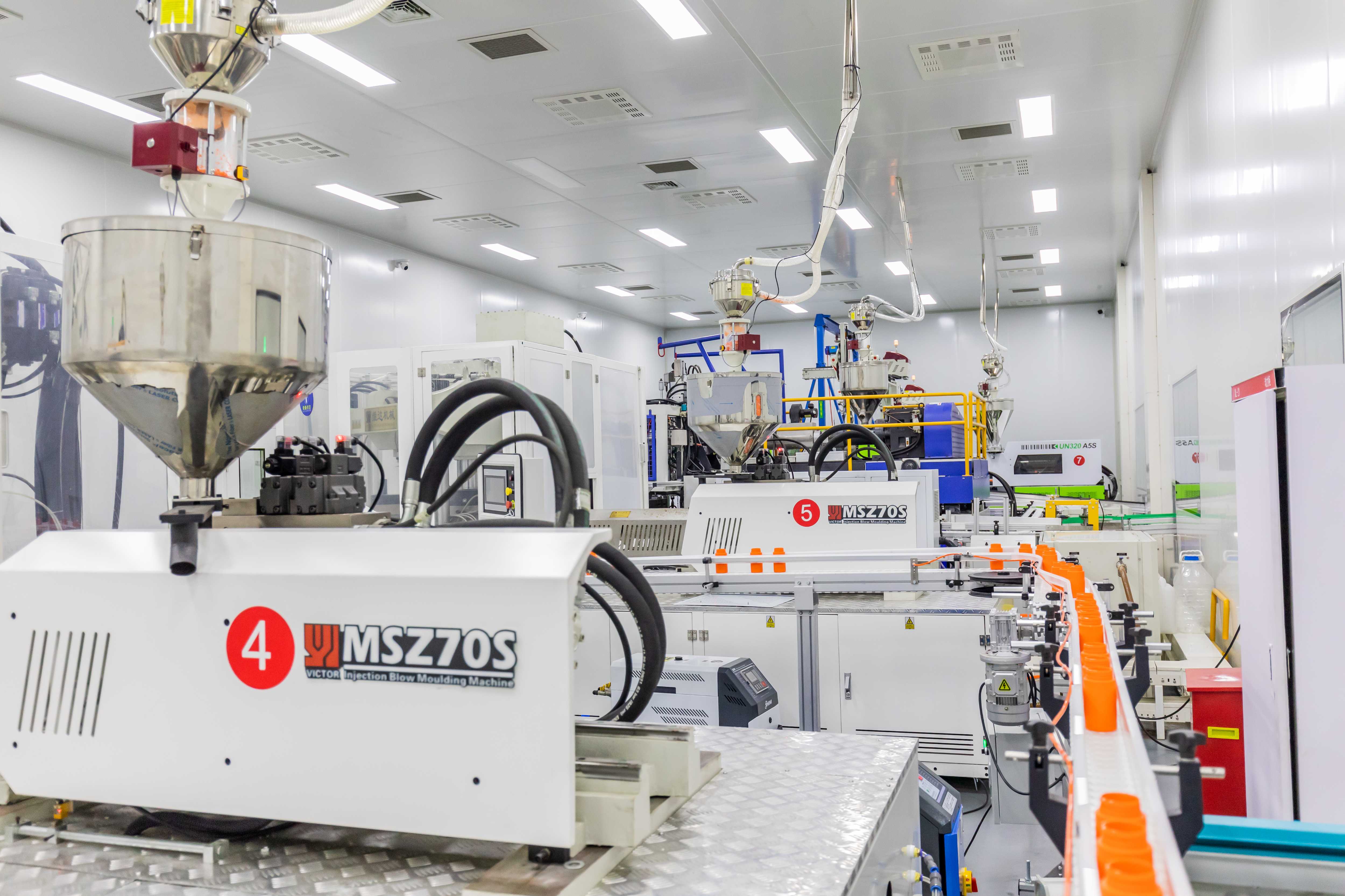 Injection molding and blow molding machinery inside a certified plastic packaging manufacturing facility