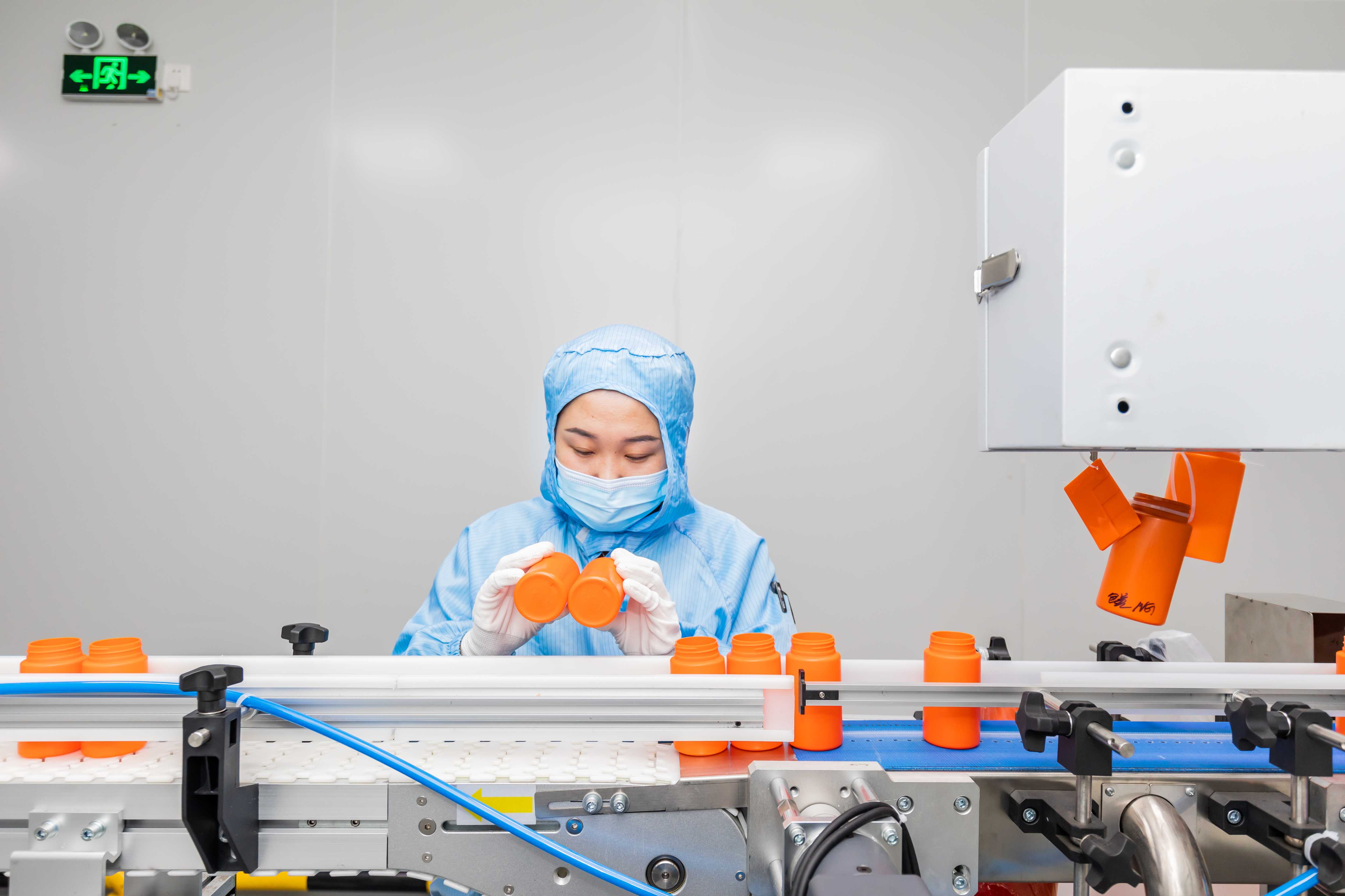 In-factory quality control inspection of sports nutrition supplement bottles and lids