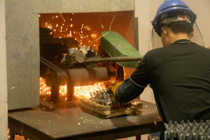 Bake in a high-temperature furnace; grind off casting marks, burrs, and parting lines