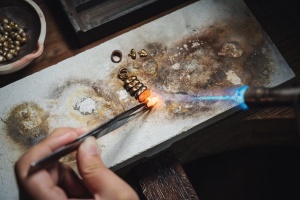 Melting solder using a flame