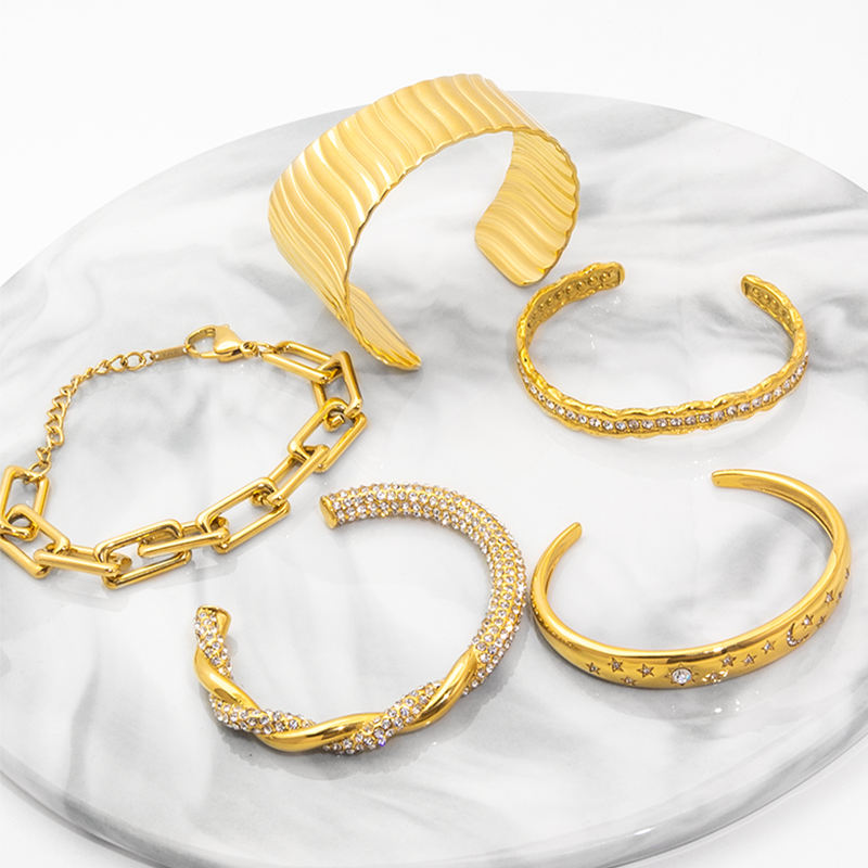 Stainless steel bangles in several diameters, showing how band diameter and thickness change the visual weight of a piece