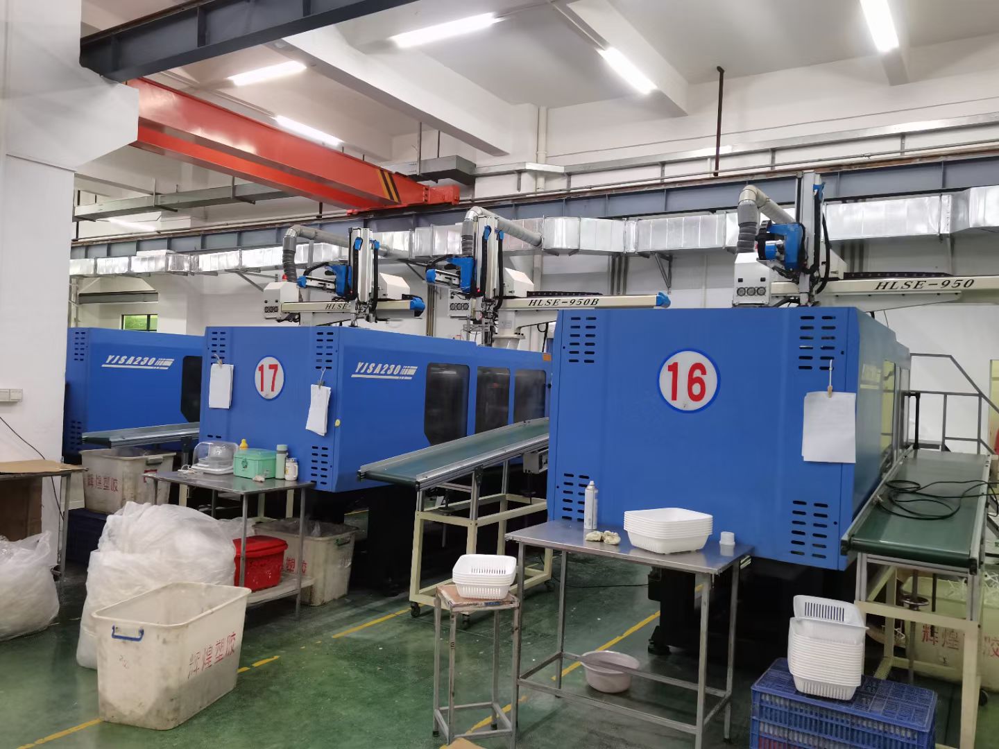 PET preform injection machine running on the production floor of a bottle-making factory