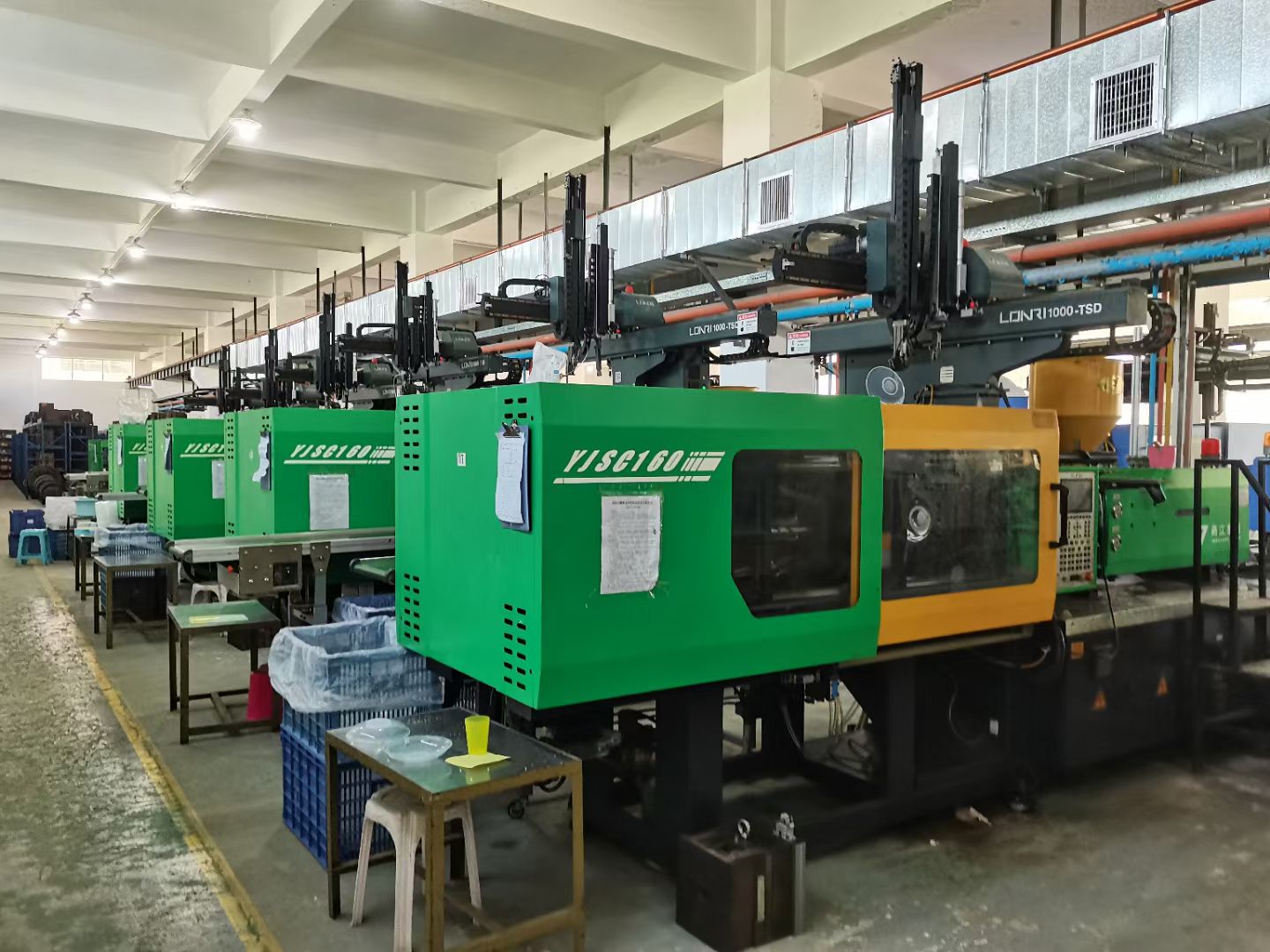 PET preform injection machine operating in a beverage bottle factory