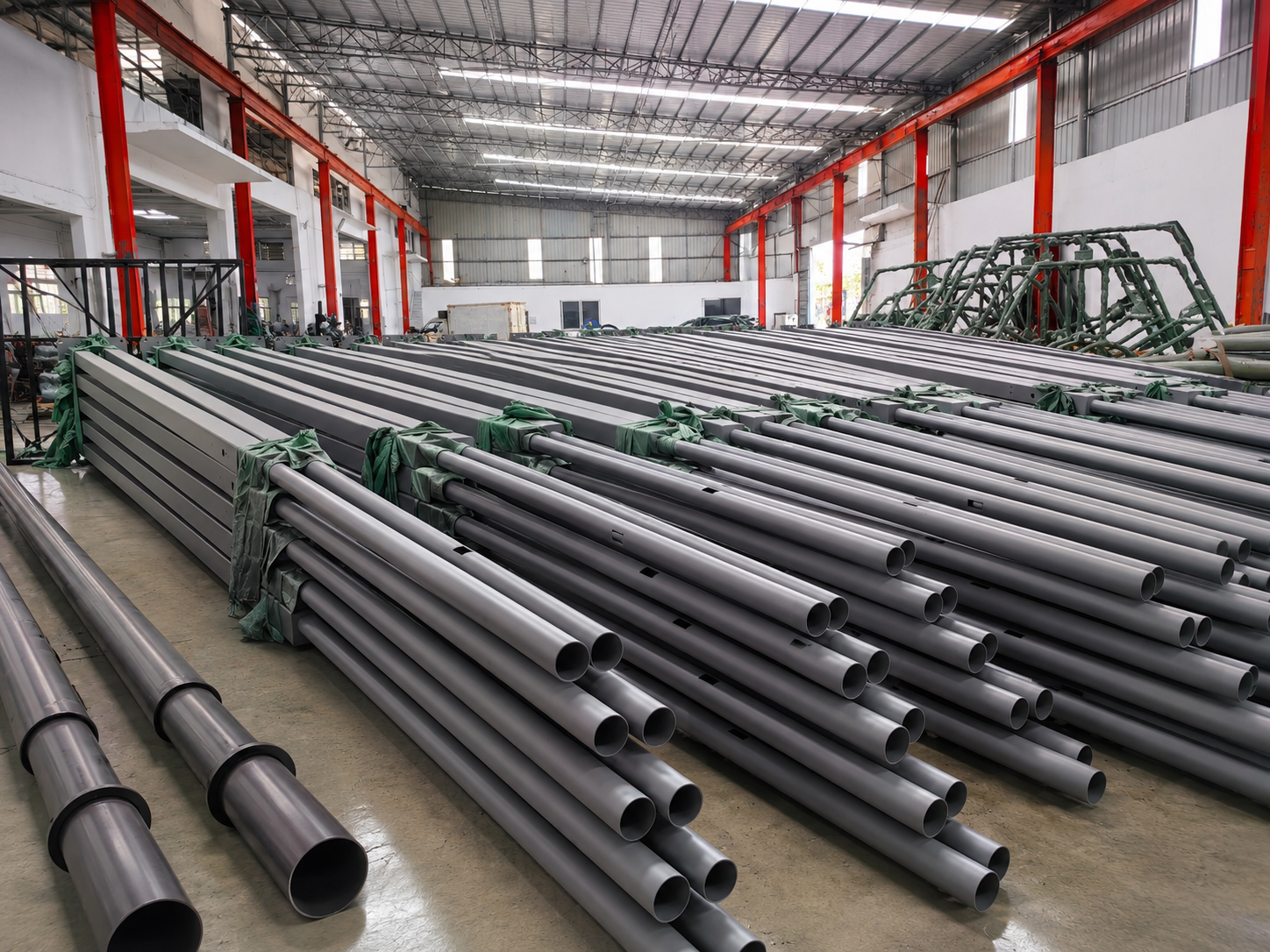 Custom light poles in storage at BAIFU production facility