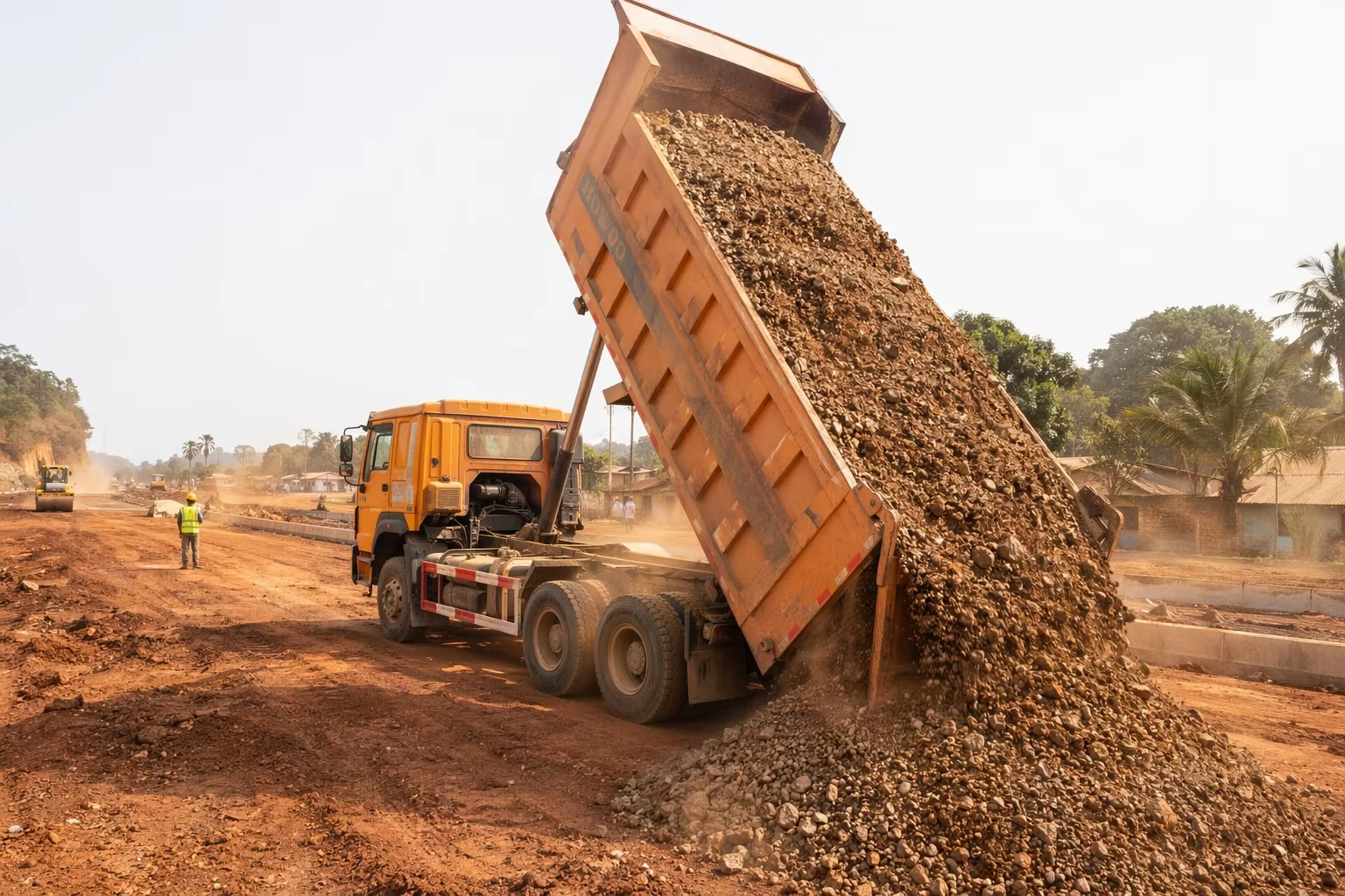 Dump truck loading and unloading cycle on a construction material haul site