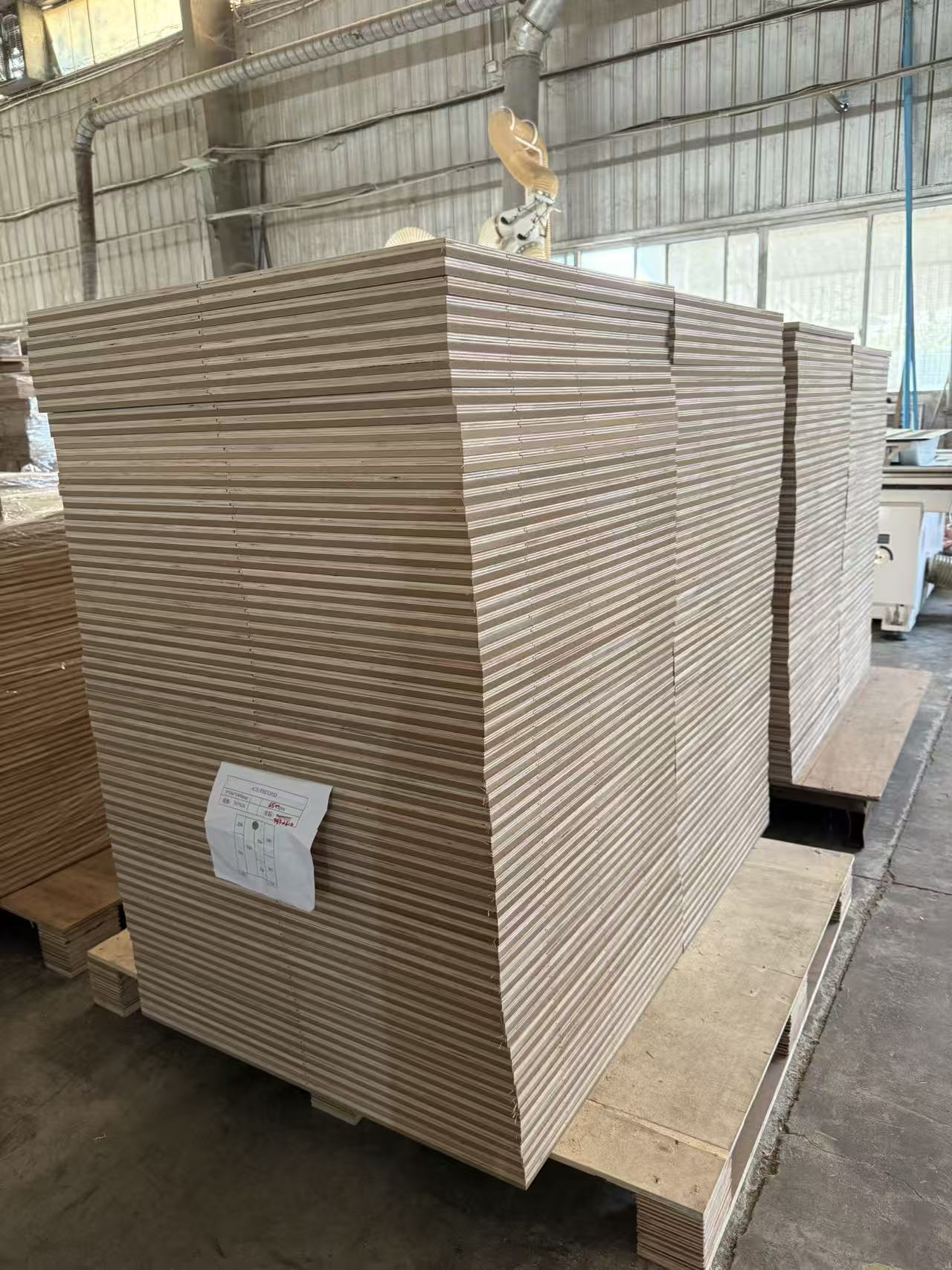 Display board showing engineered wood flooring surface options in a production facility
