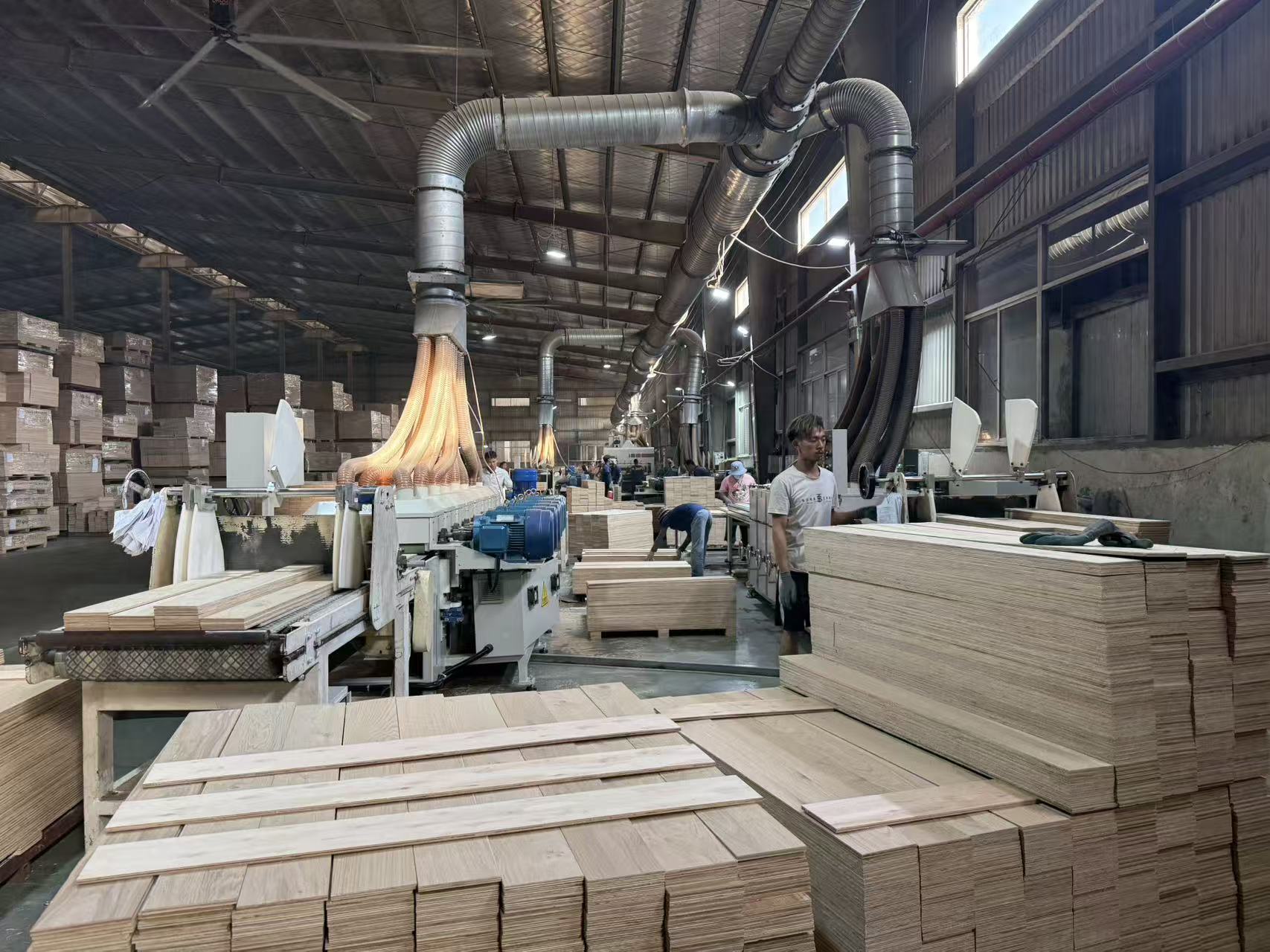 Automated grooving line inside an engineered wood flooring factory