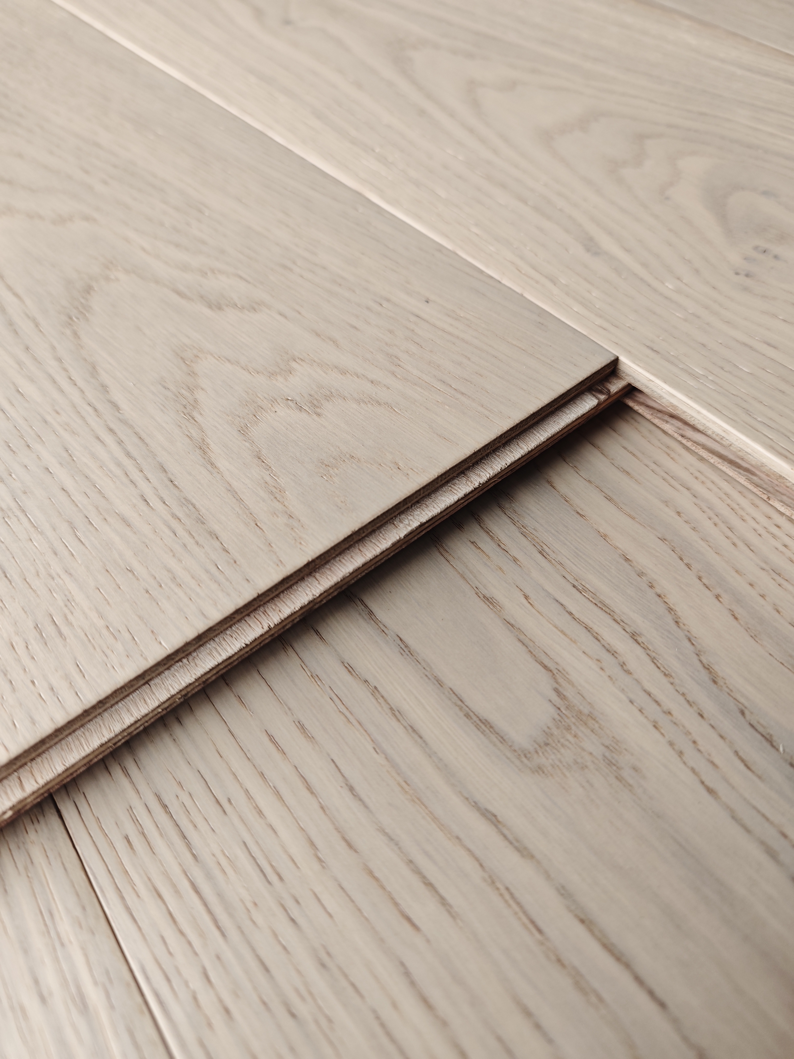 Detail view of a multi-layer engineered wood flooring plank surface and edge