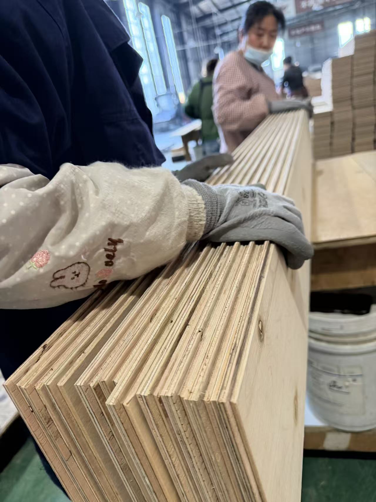 Piece-by-piece inspection of engineered wood flooring before shipment