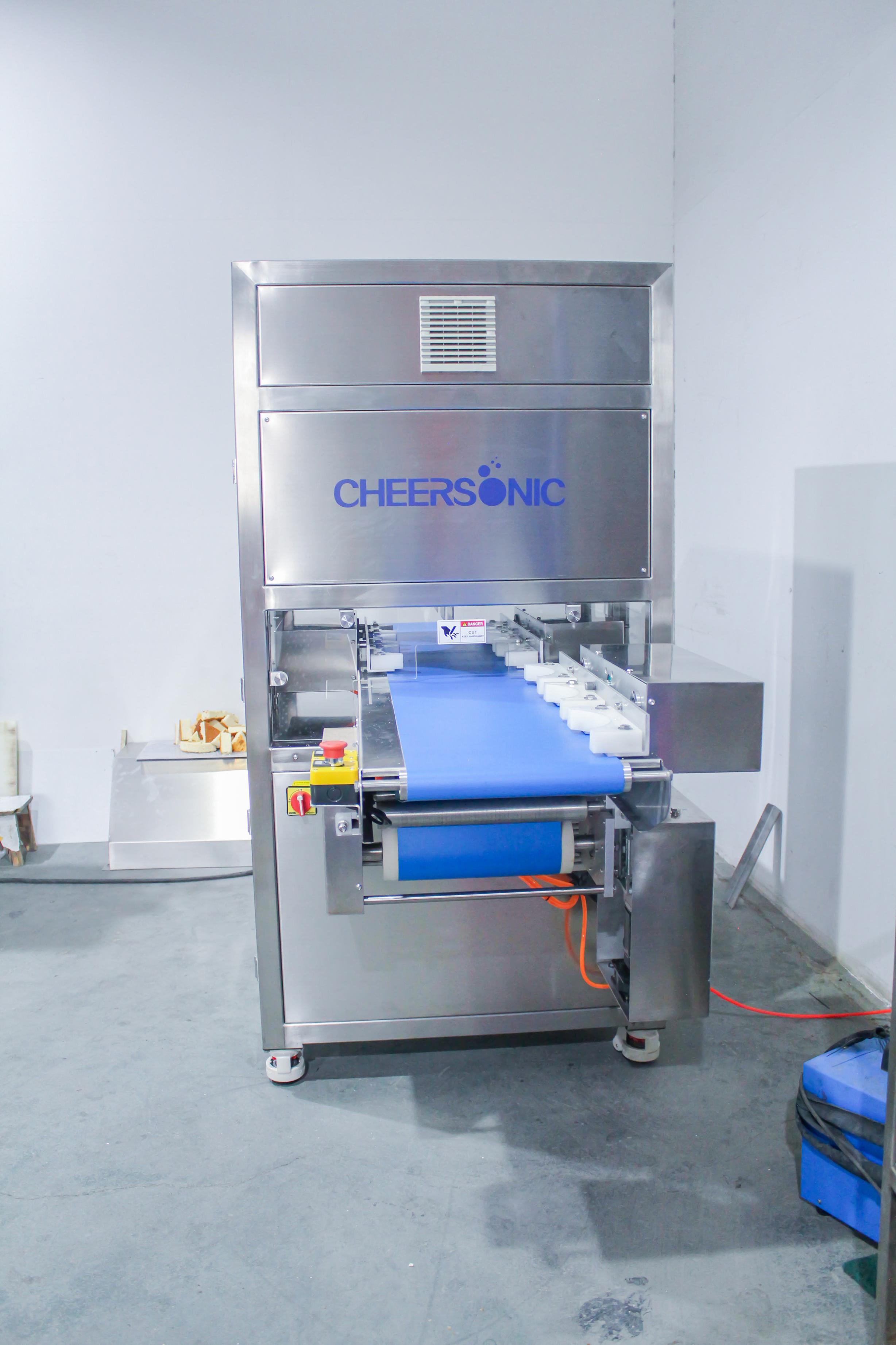 Ultrasonic food cutting machine used on an industrial bakery and dairy production line