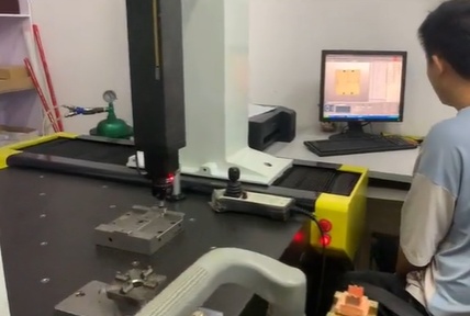 Mass production injection molding workcell with stacked parts ready for inspection