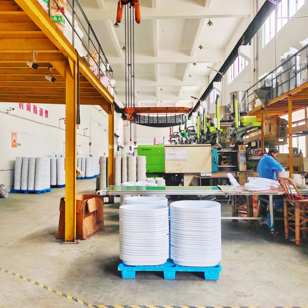 Production area of a folding basket factory with assembly lines for collapsible household plasticware