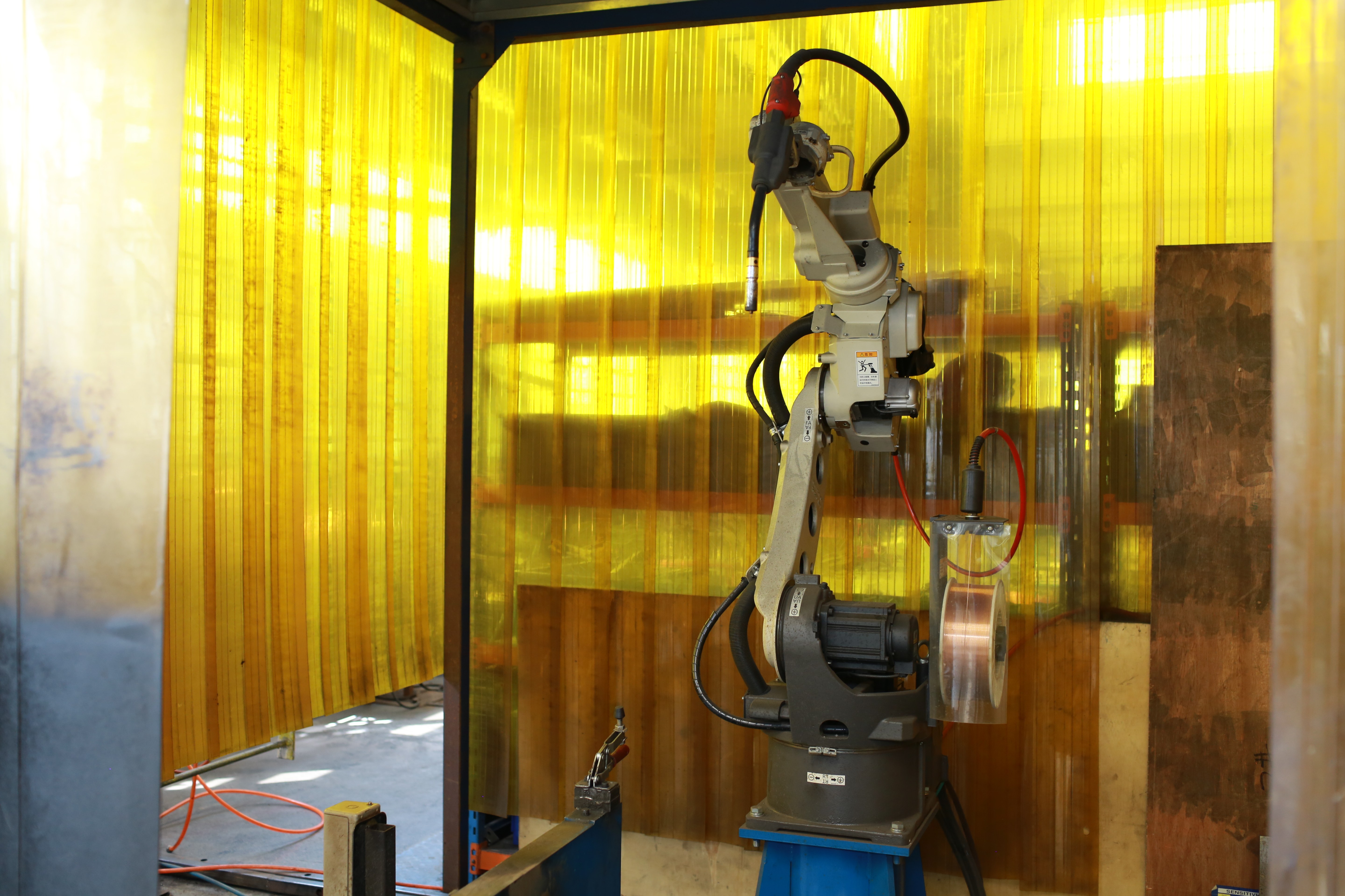 Robotic welding arm joining stamped sheet metal components
