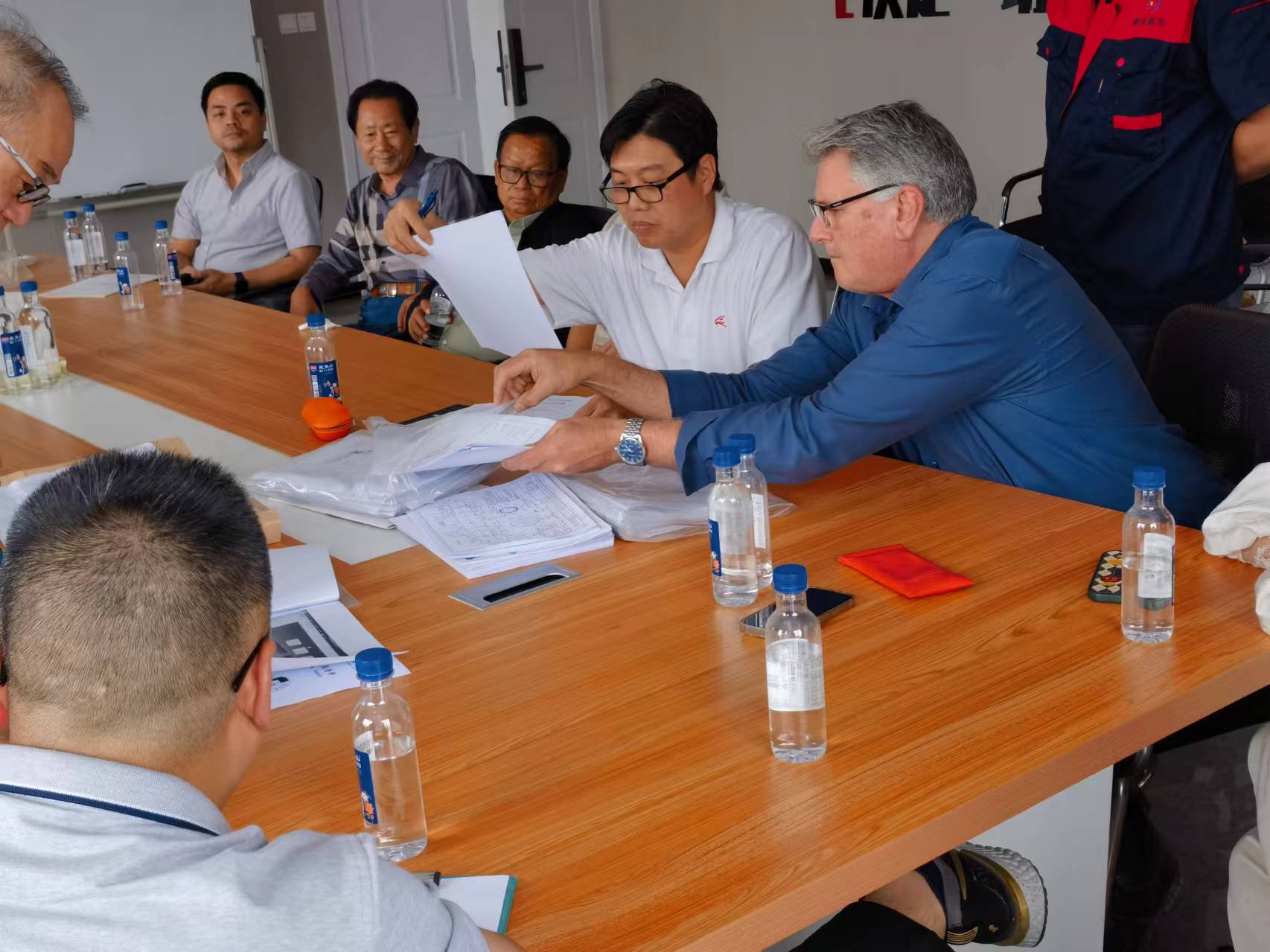 Customer tours a nonwoven fabric machine production facility during supplier evaluation