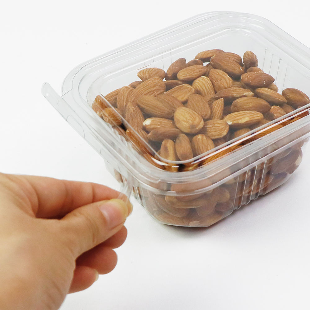 Clear PET clamshell container with tamper-evident seal used for fresh produce packaging