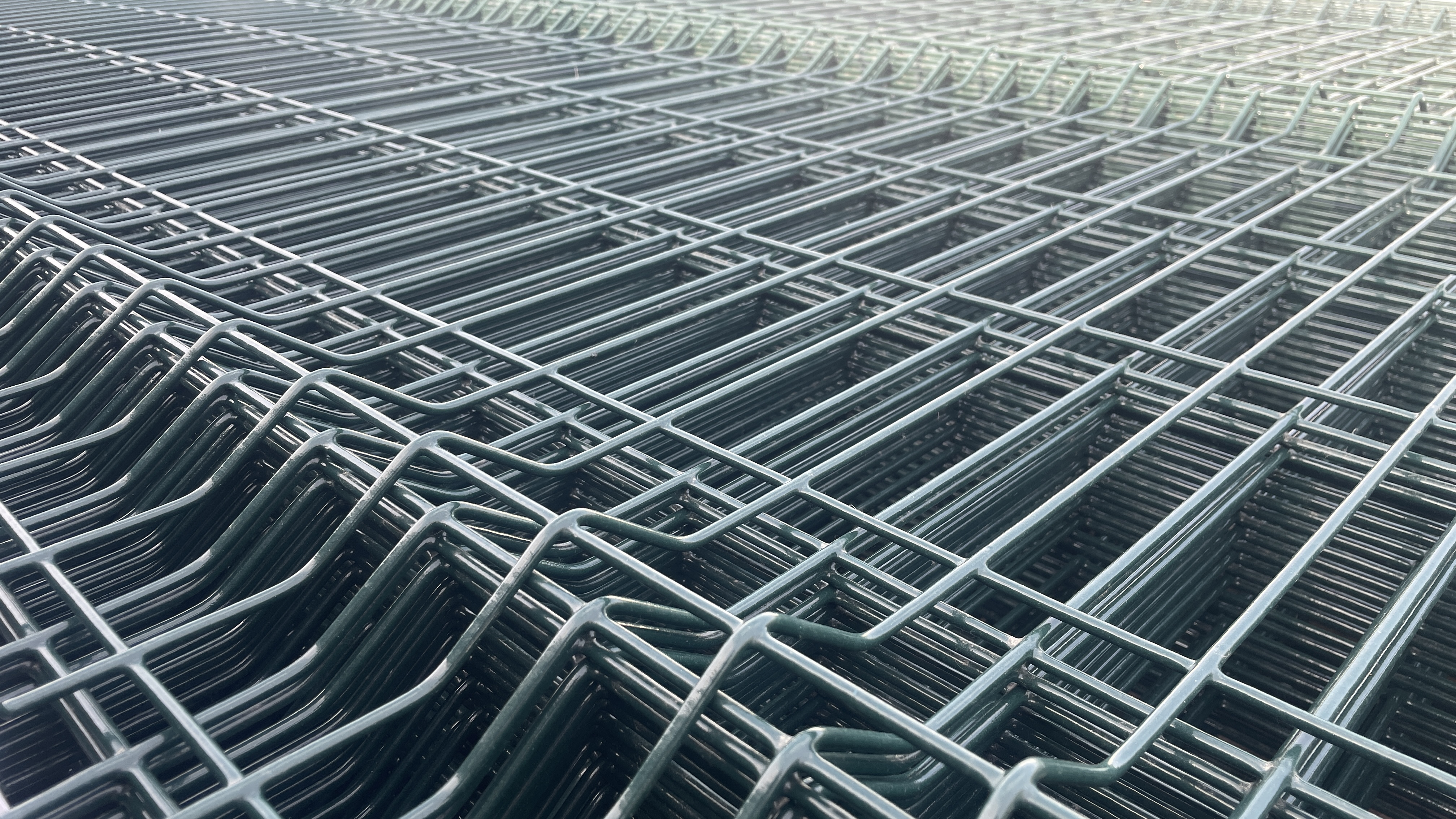 Welded mesh fence installation at an industrial perimeter