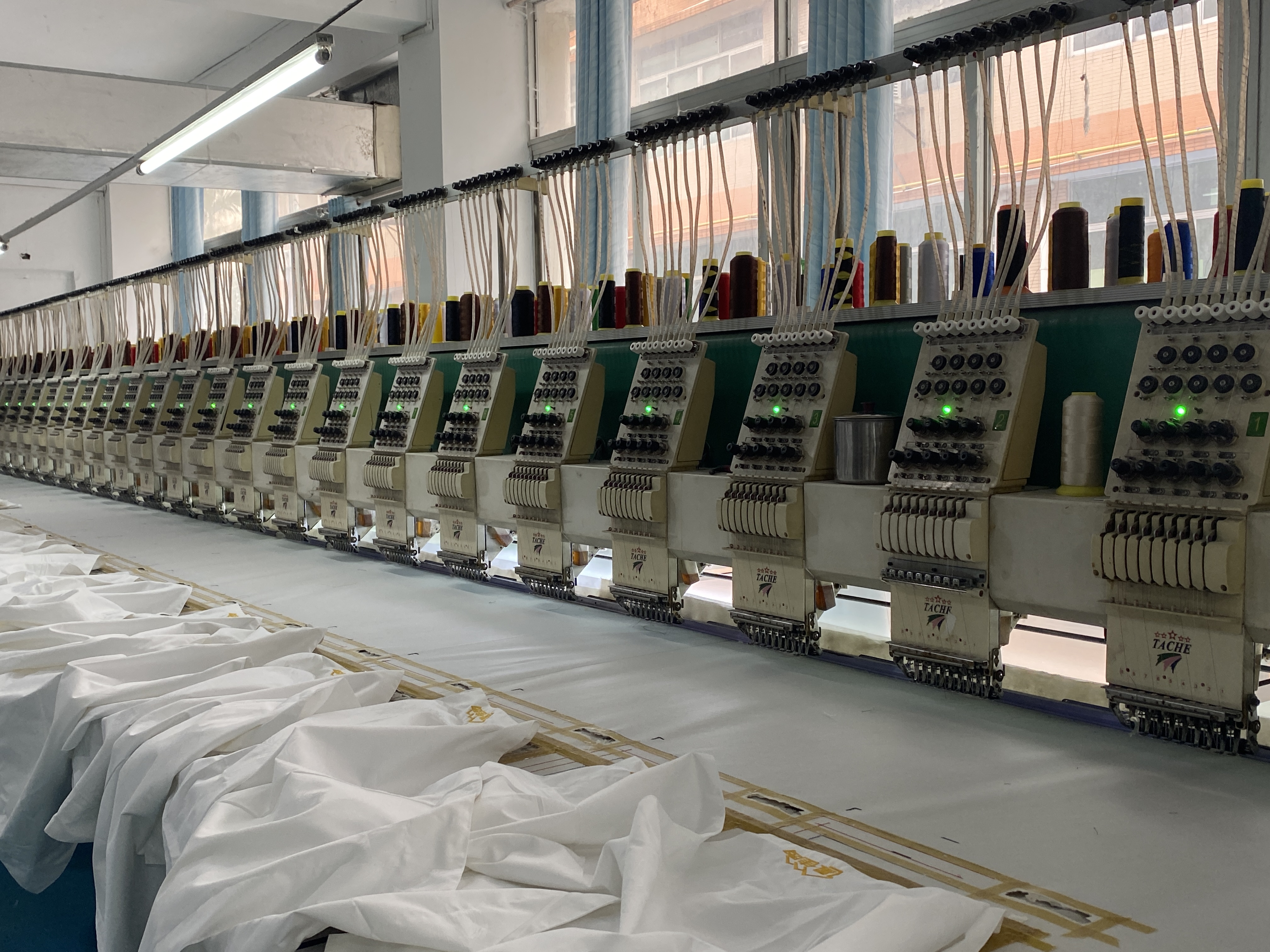 Embroidery workshop at Weisdin factory producing custom logo textiles