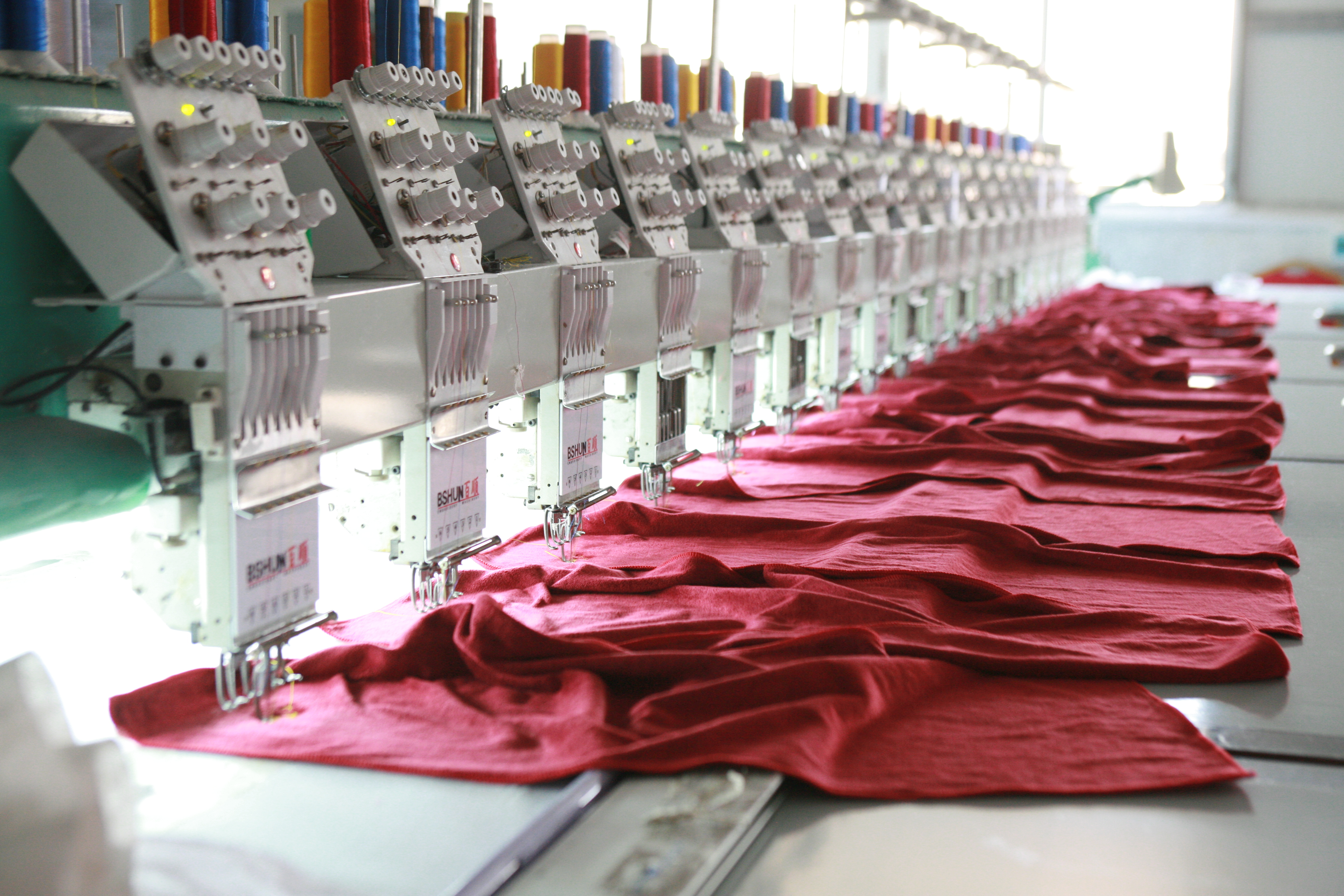 Embroidery workshop at WEISDIN producing custom hotel logo textiles