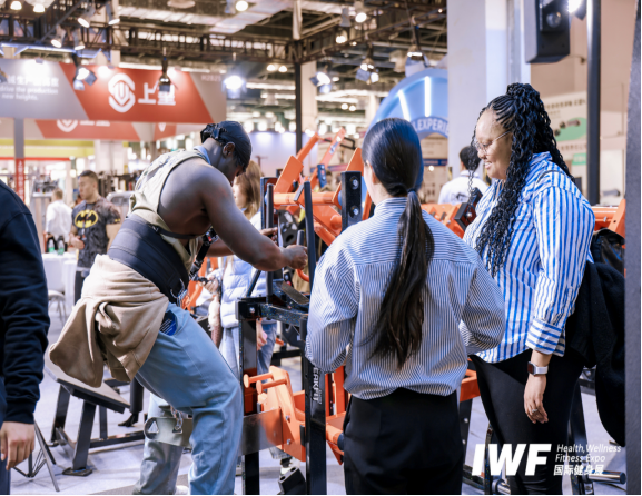 Buyer testing fitness equipment at a gym equipment expo Asia event