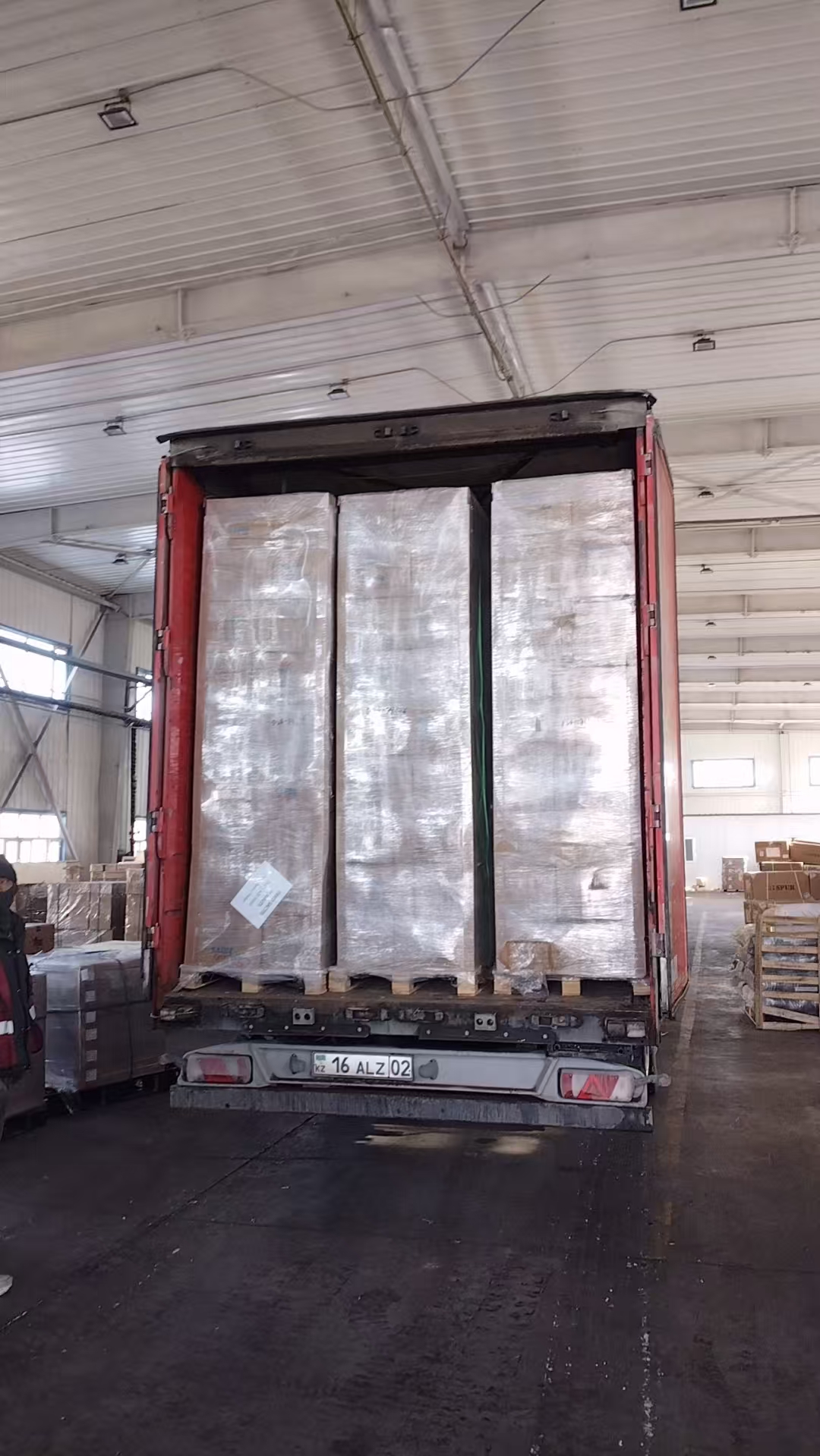 Canned food cartons being loaded into a container for long-distance sea transport