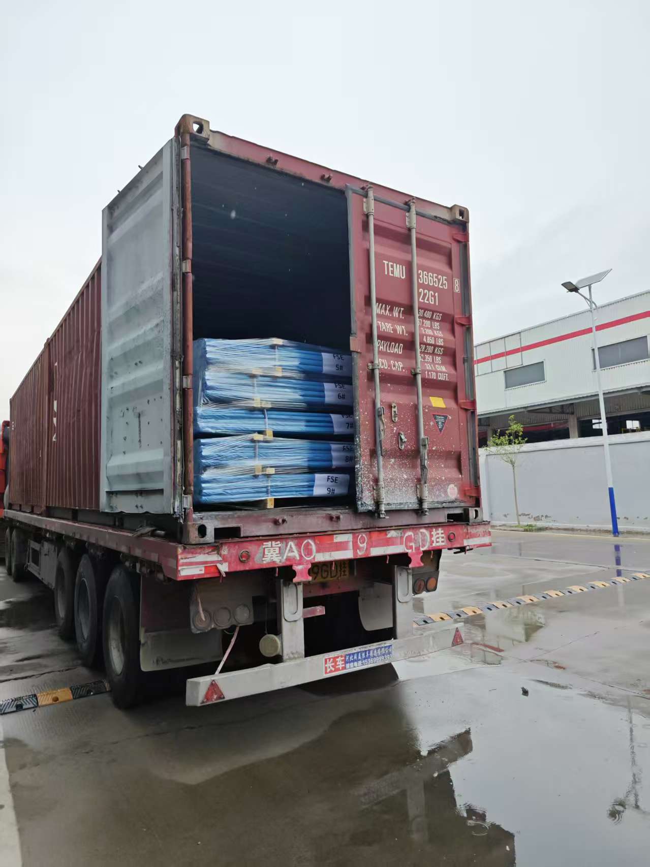 On-site photo of loading export shipping container with palletised fasteners for global projects