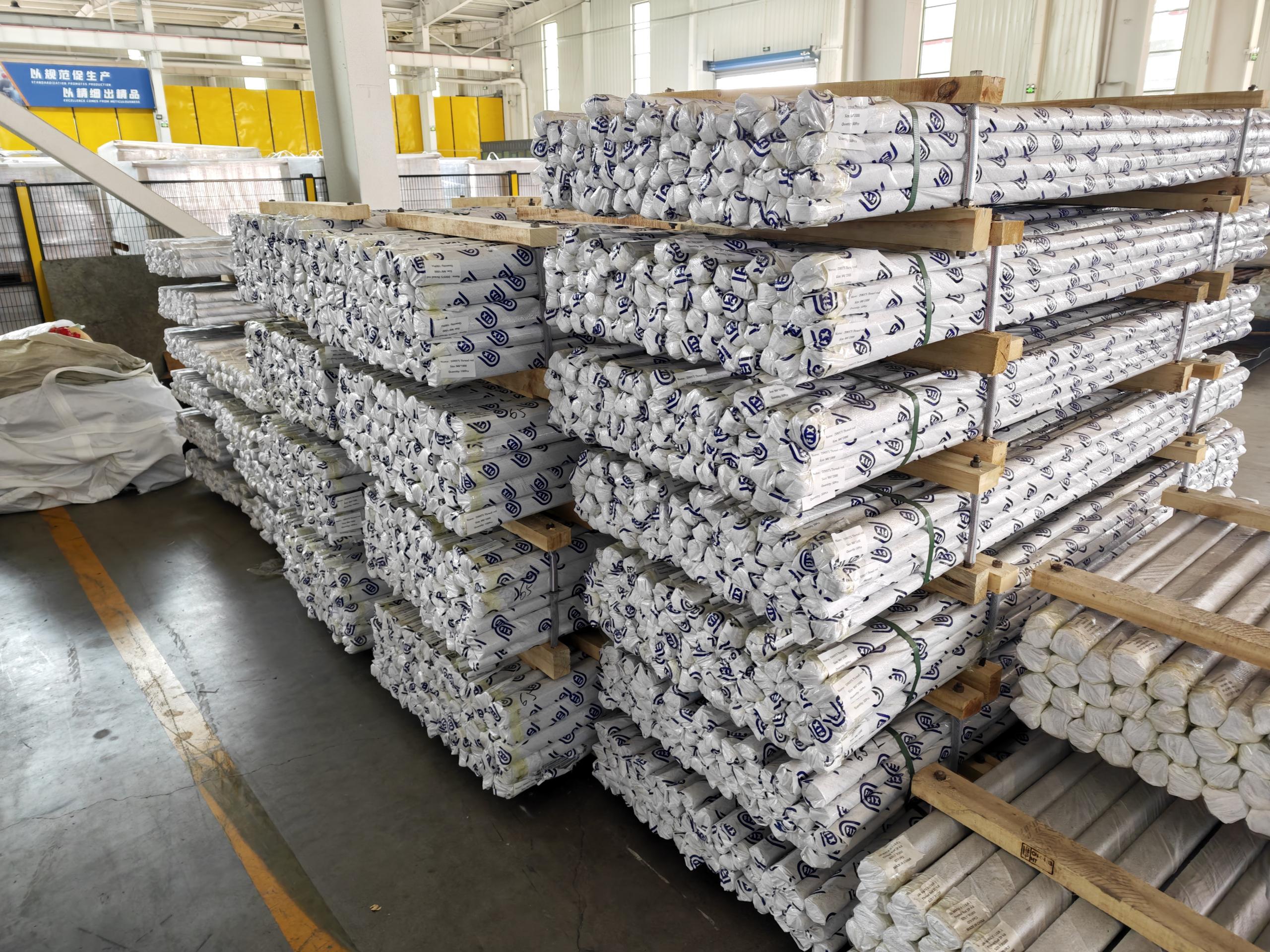 Film-wrapped pallets of long sleeve anchor finished products in warehouse