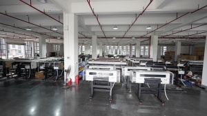 A spacious Xinflying production area displays numerous completed DTF printers arranged in orderly rows.