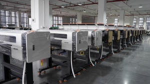 Rows of packaged and unpackaged Xinflying DTF printers are neatly aligned across the factory floor.