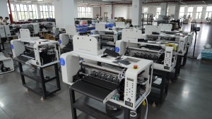 Rows of compact Xinflying DTF printers are arranged for assembly, testing, and quality inspection.