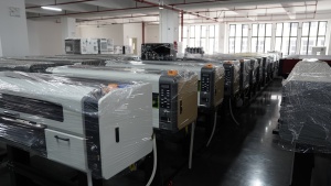 Completed Xinflying DTF printers are fully wrapped in protective film and lined up for storage or delivery.